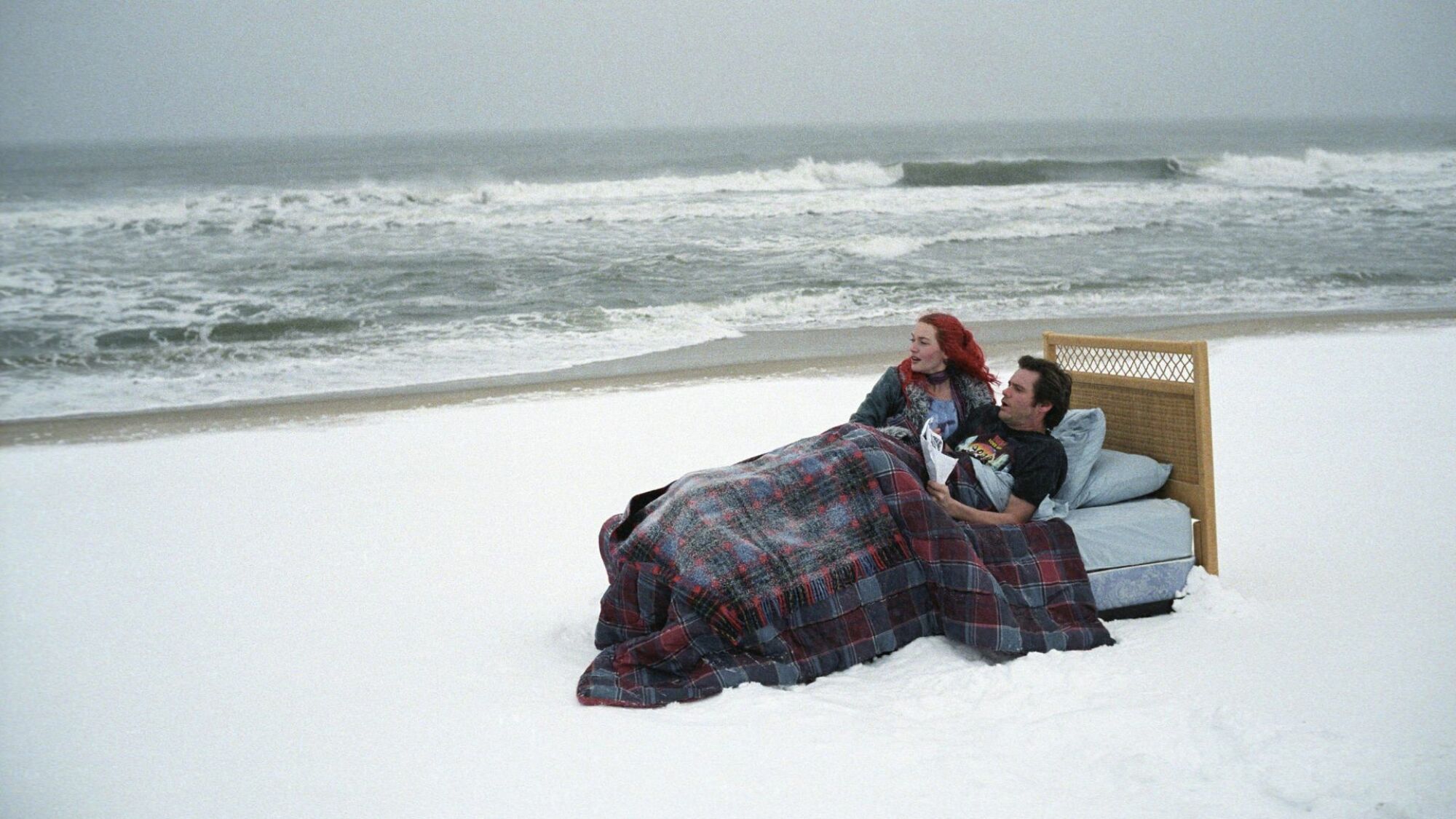 Kate Winslet and Jim Carrey lie in bed on a beach in "Eternal Sunshine of the Spotless Mind."