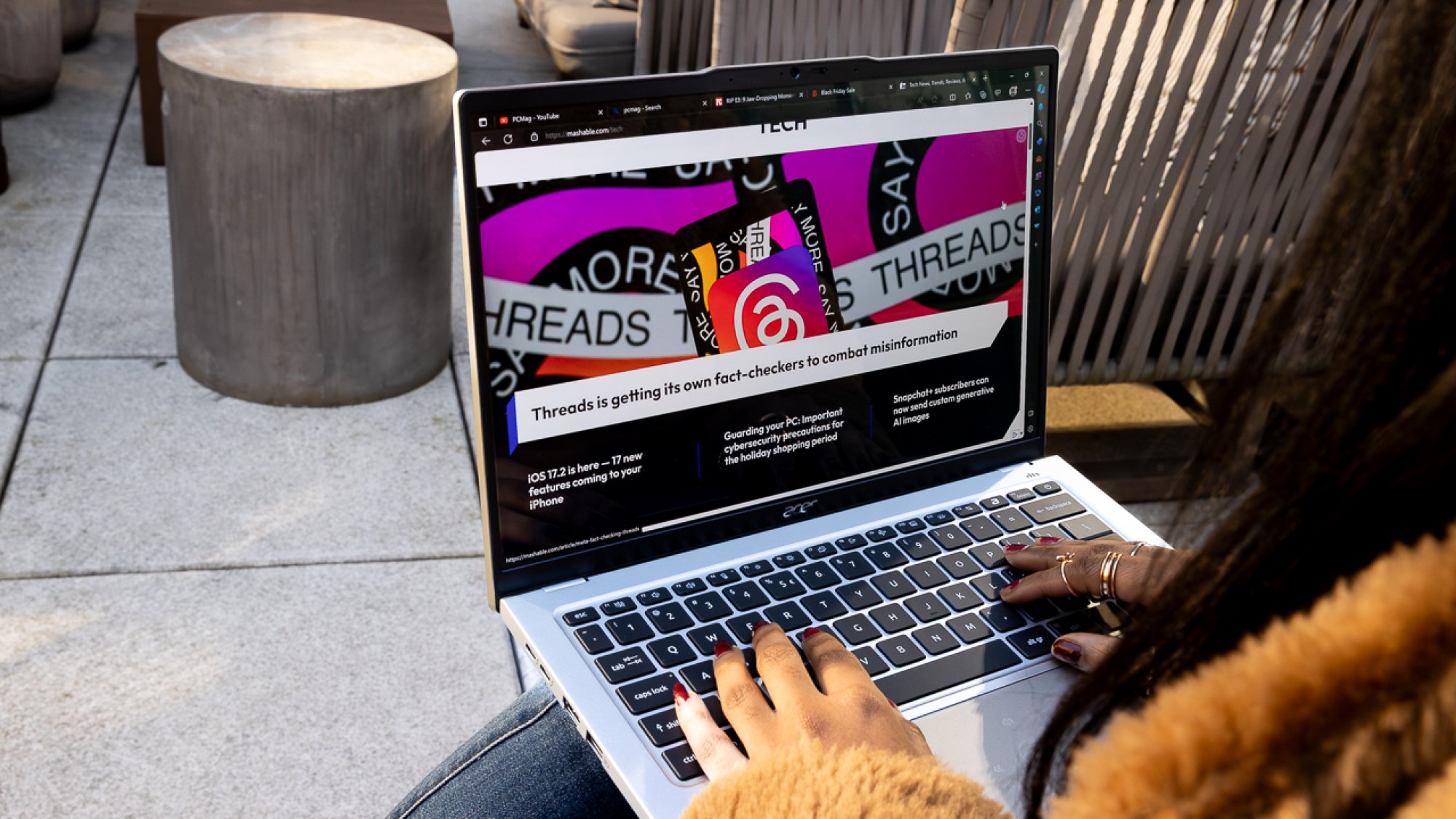 Woman holding the Acer Swift Go 14 on her lap