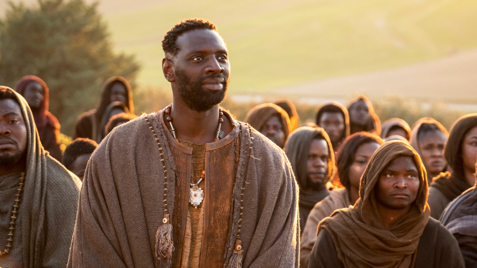 A man stands in a crowd attentively listening.