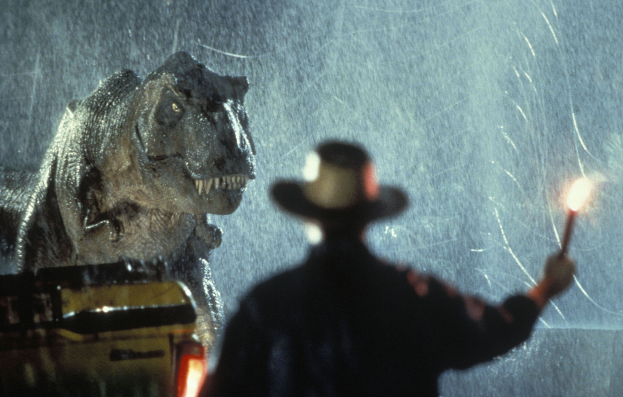 A T-Rex approaches a man.