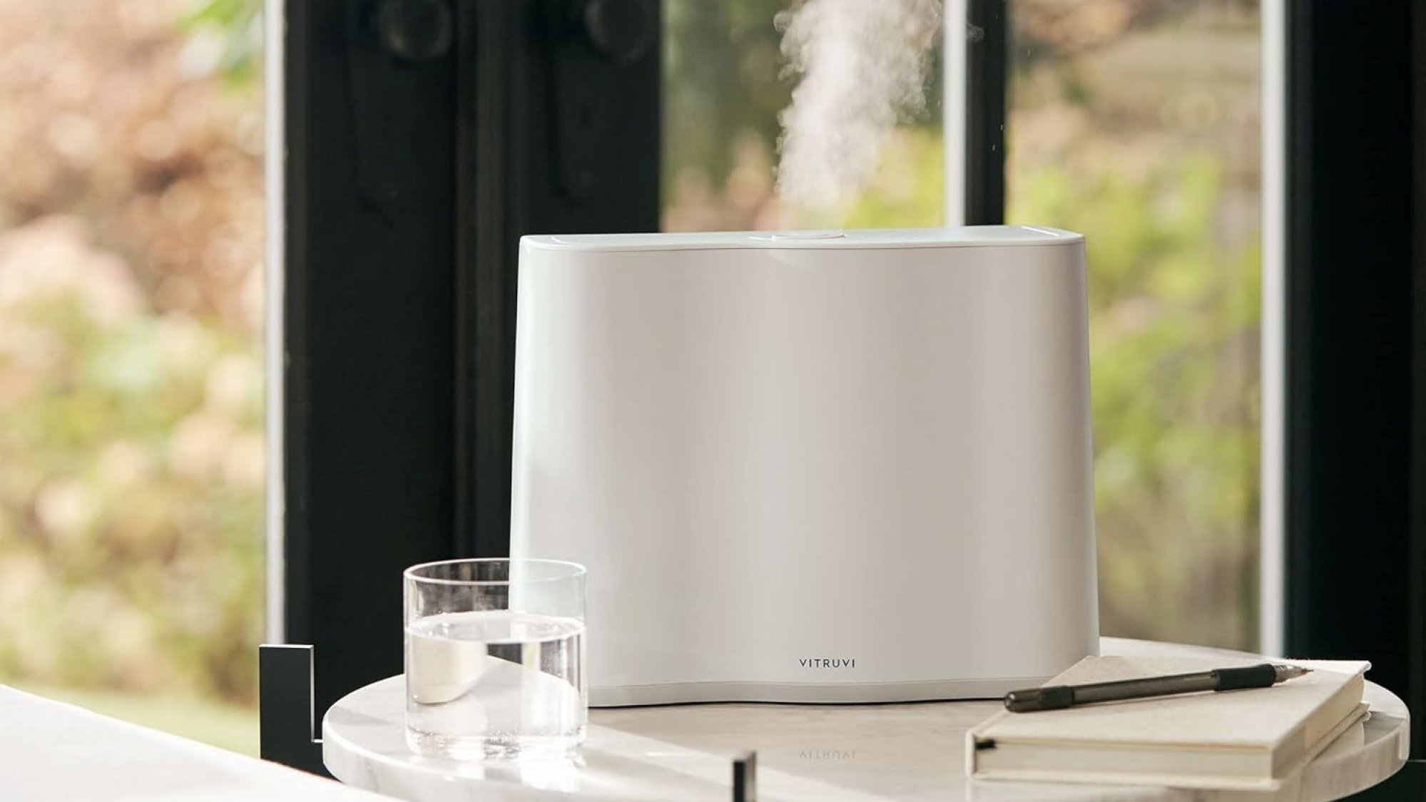 white vitruvi humidifer in living room