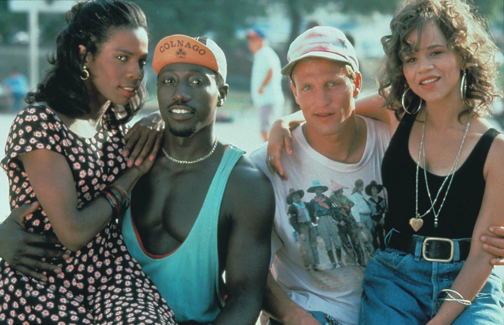 Two women sit on the laps of two men in "White Men Can't Jump."