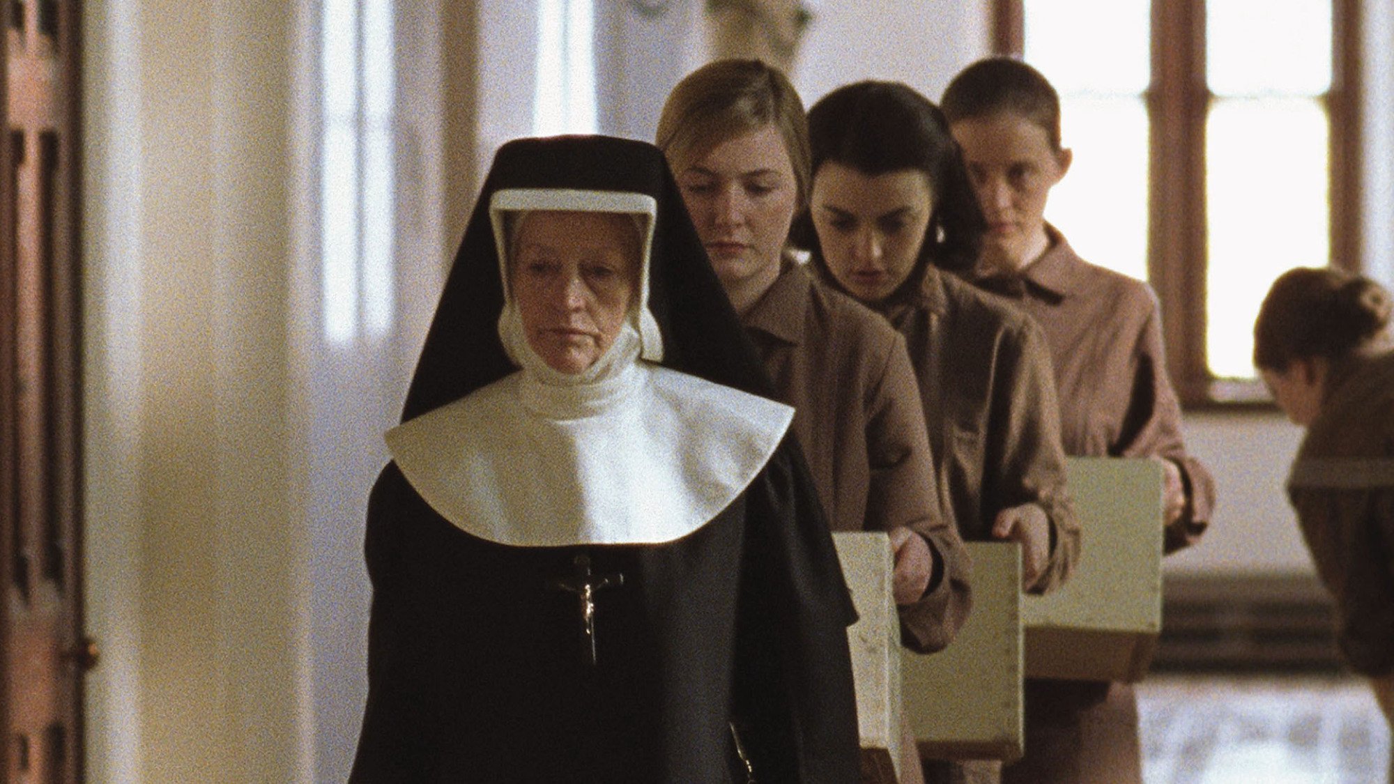 A still from 2002's "The Magdalene Sisters" by Peter Mullan showing a nun leading three women.