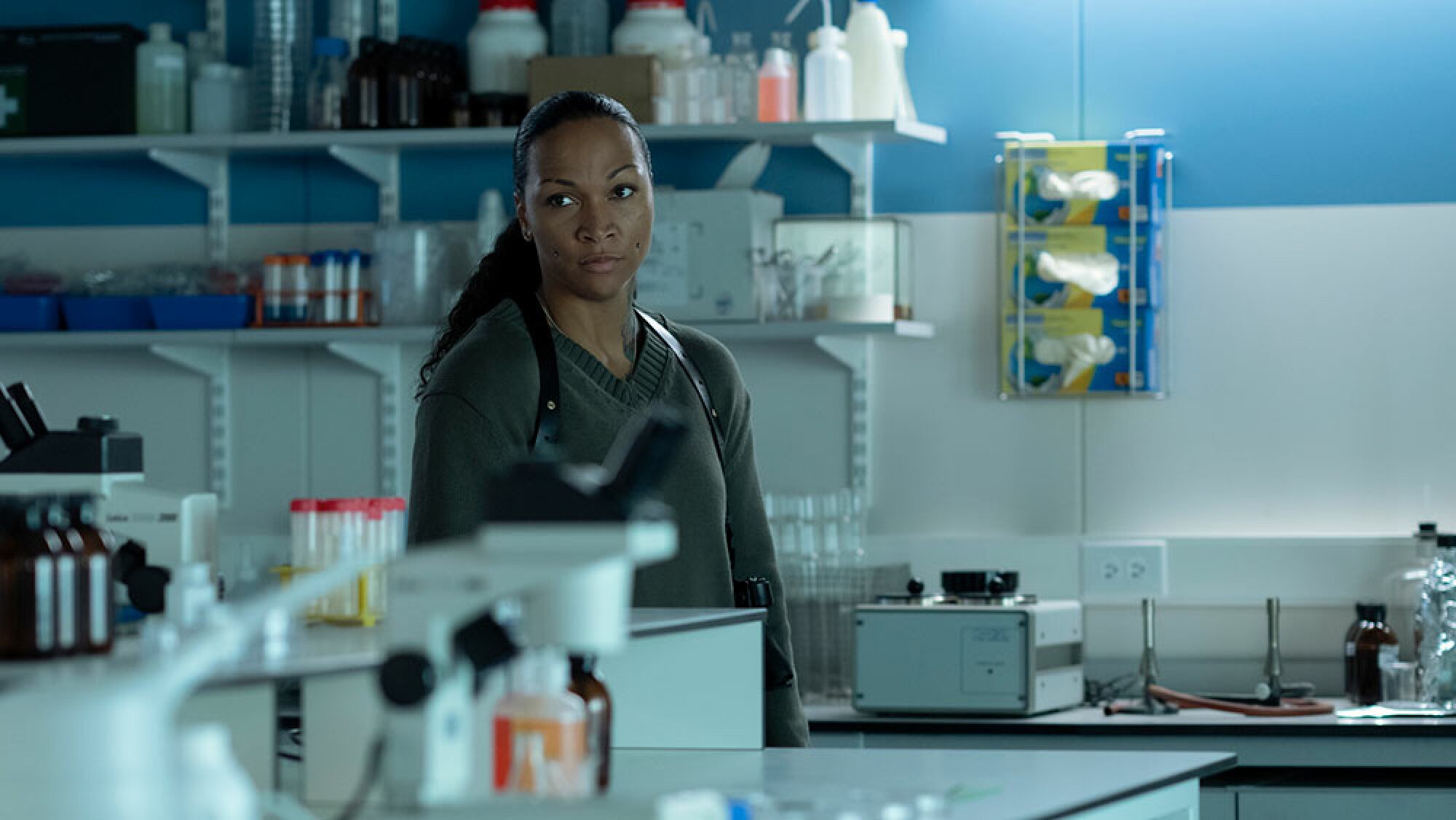 A police officer stands in a laboratory.