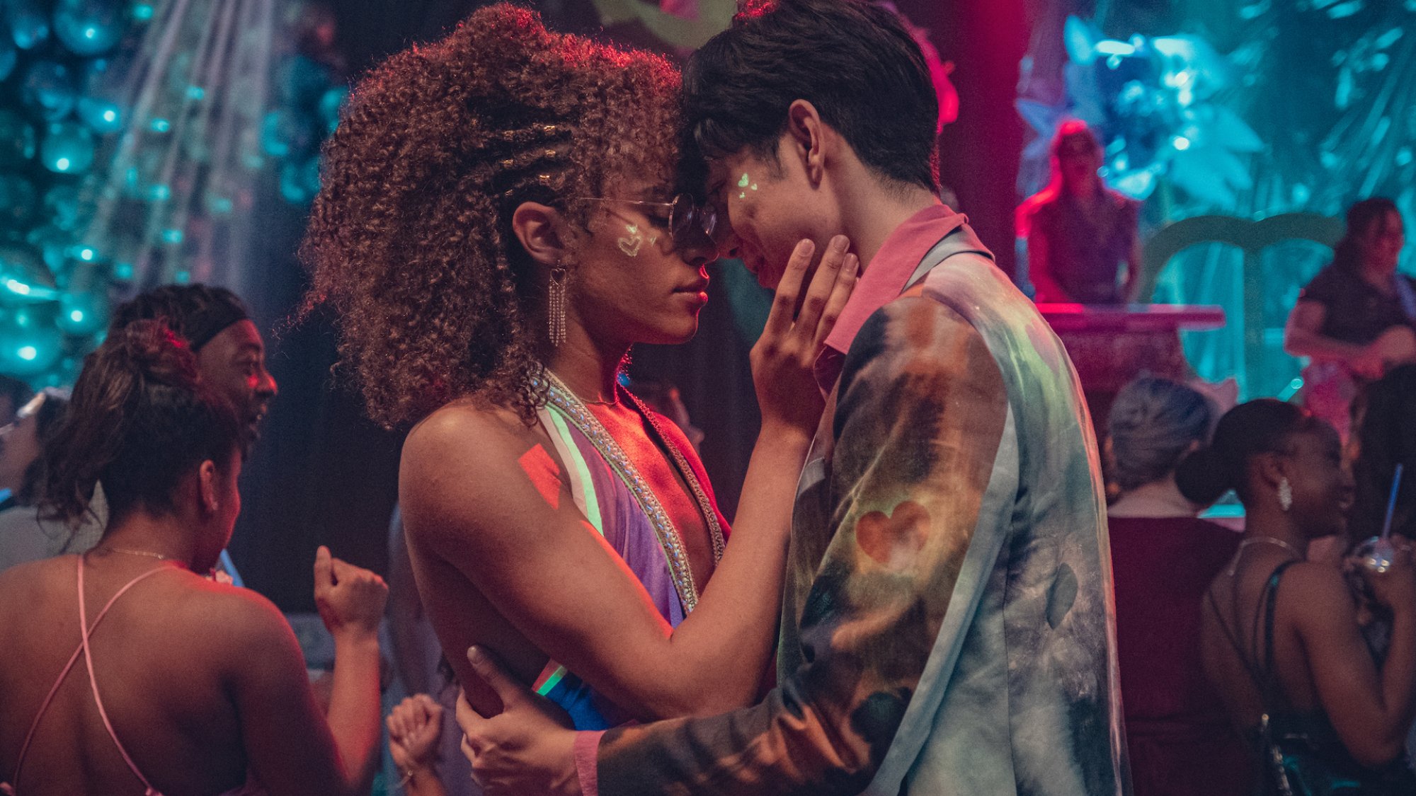 Two teens go to kiss at a prom.