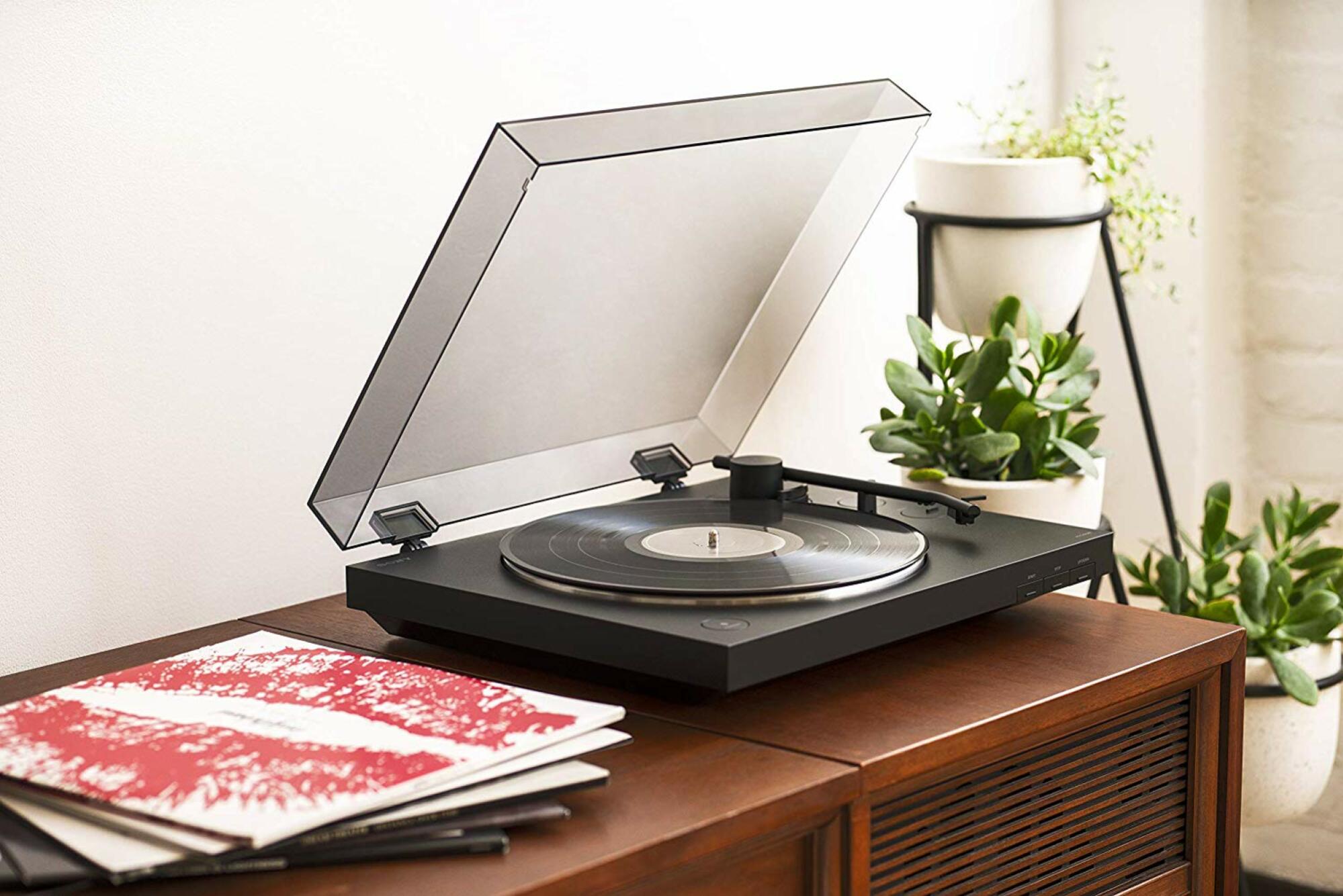 a bluetooth record player on a side table