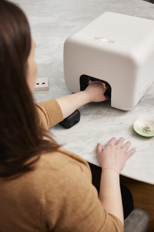 Woman putting her hand in the Nimble machine