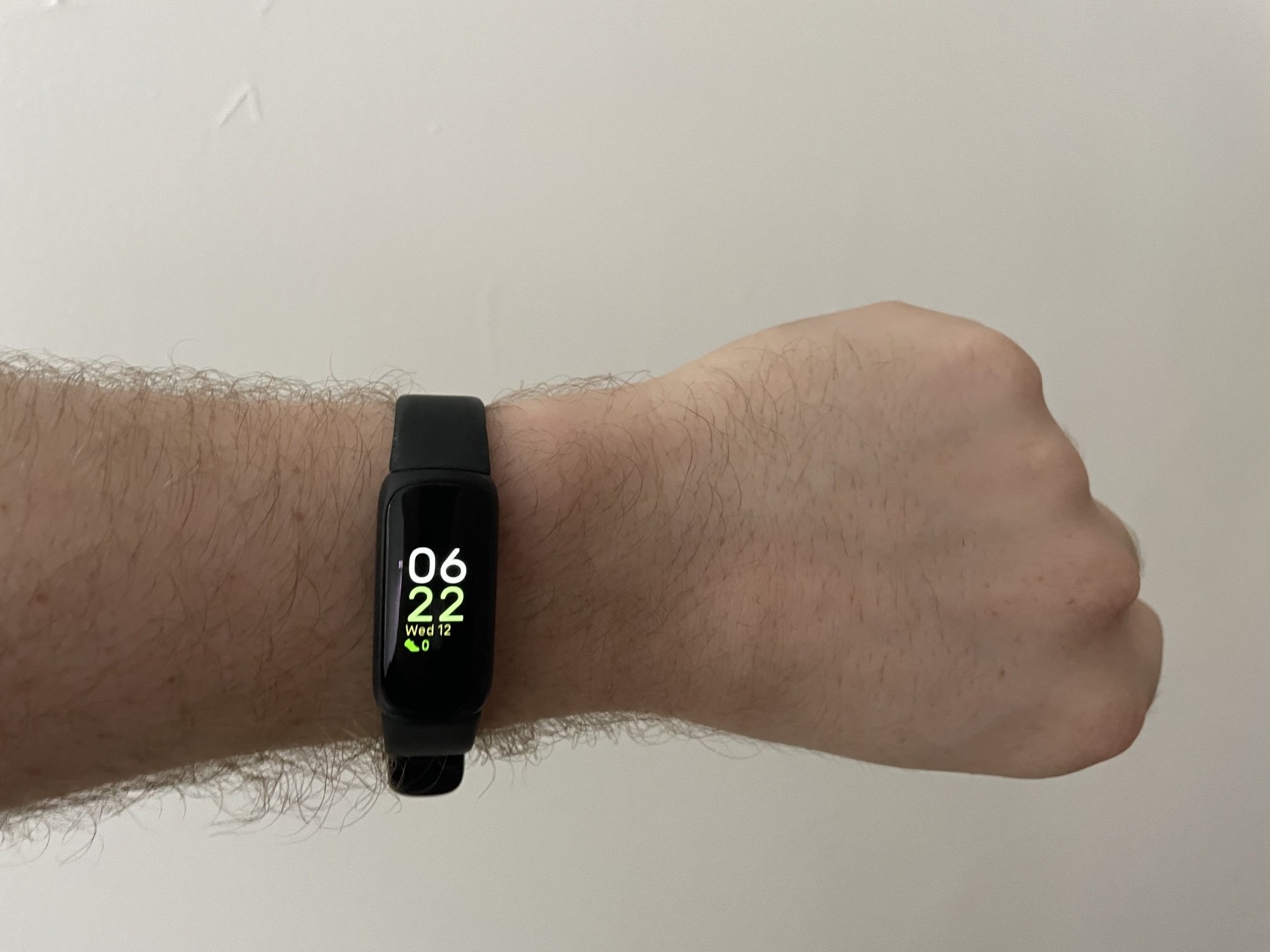 man's wrist with slim Fitbit Inspire 3 fitness tracker