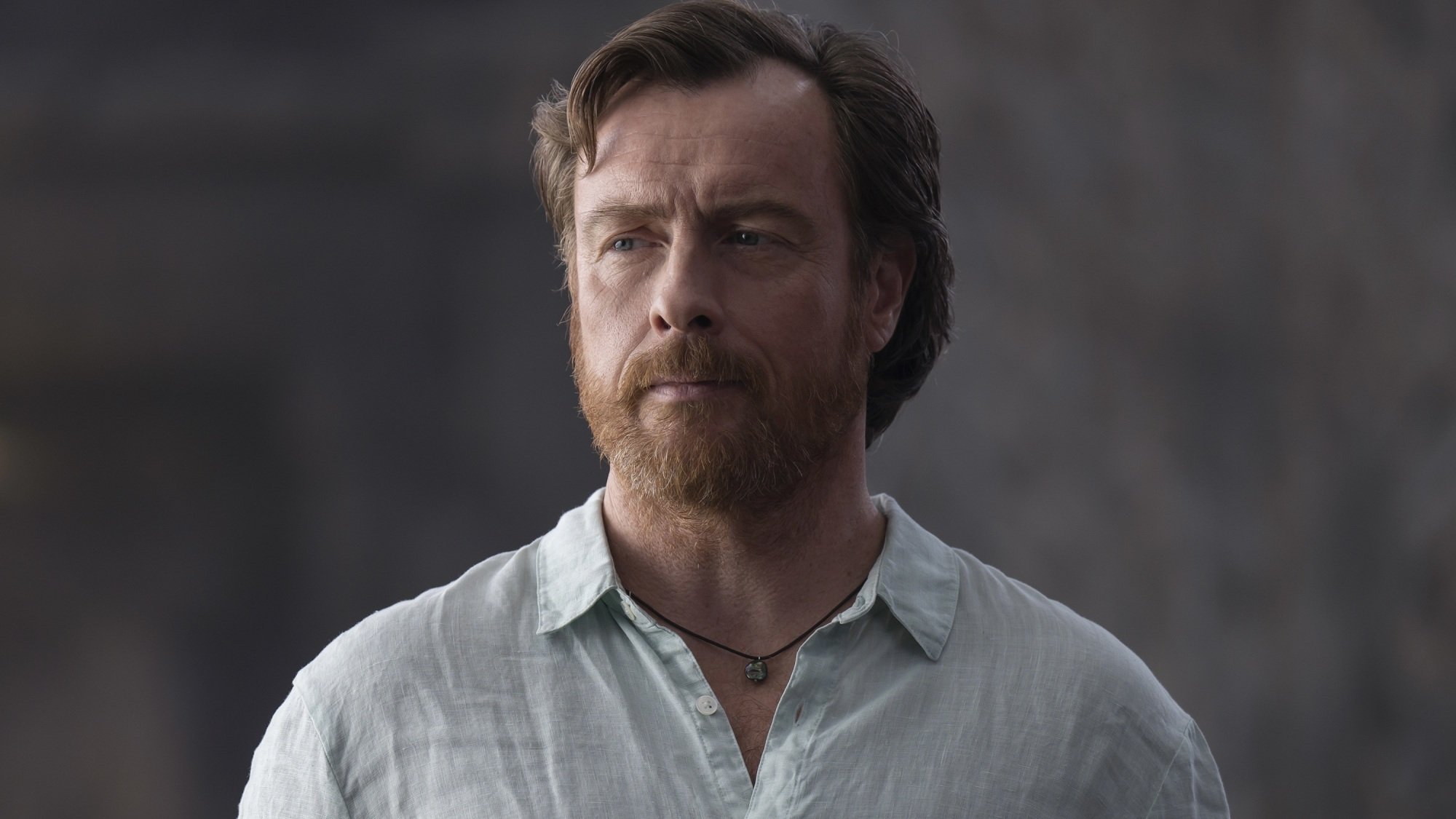 A man in a blue button-up shirt.
