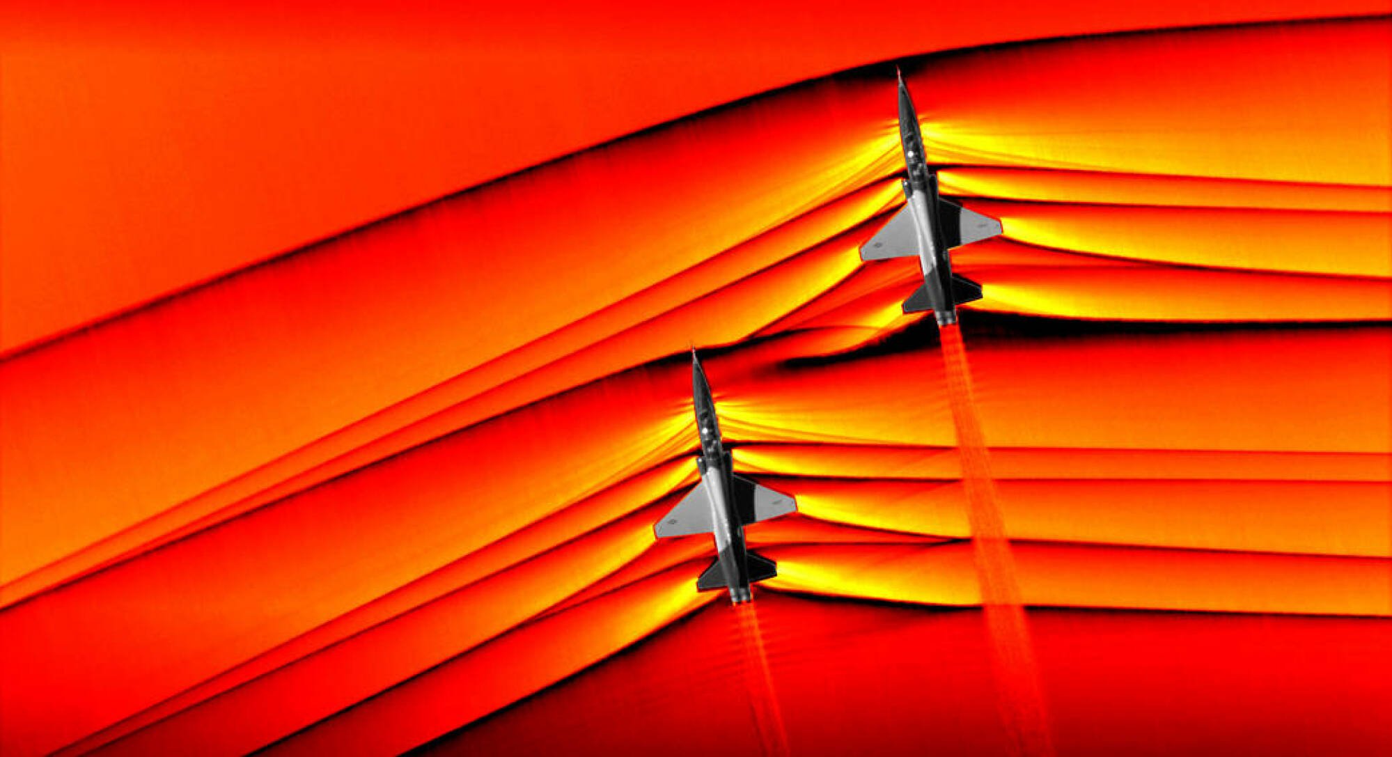 Two supersonic aircraft creating shockwaves as they travel through the atmosphere.