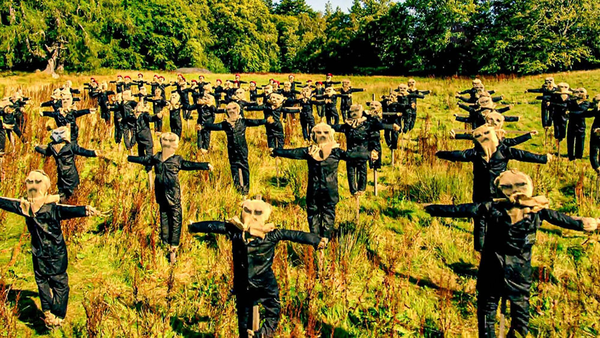A field filled with creepy-looking scarecrows.