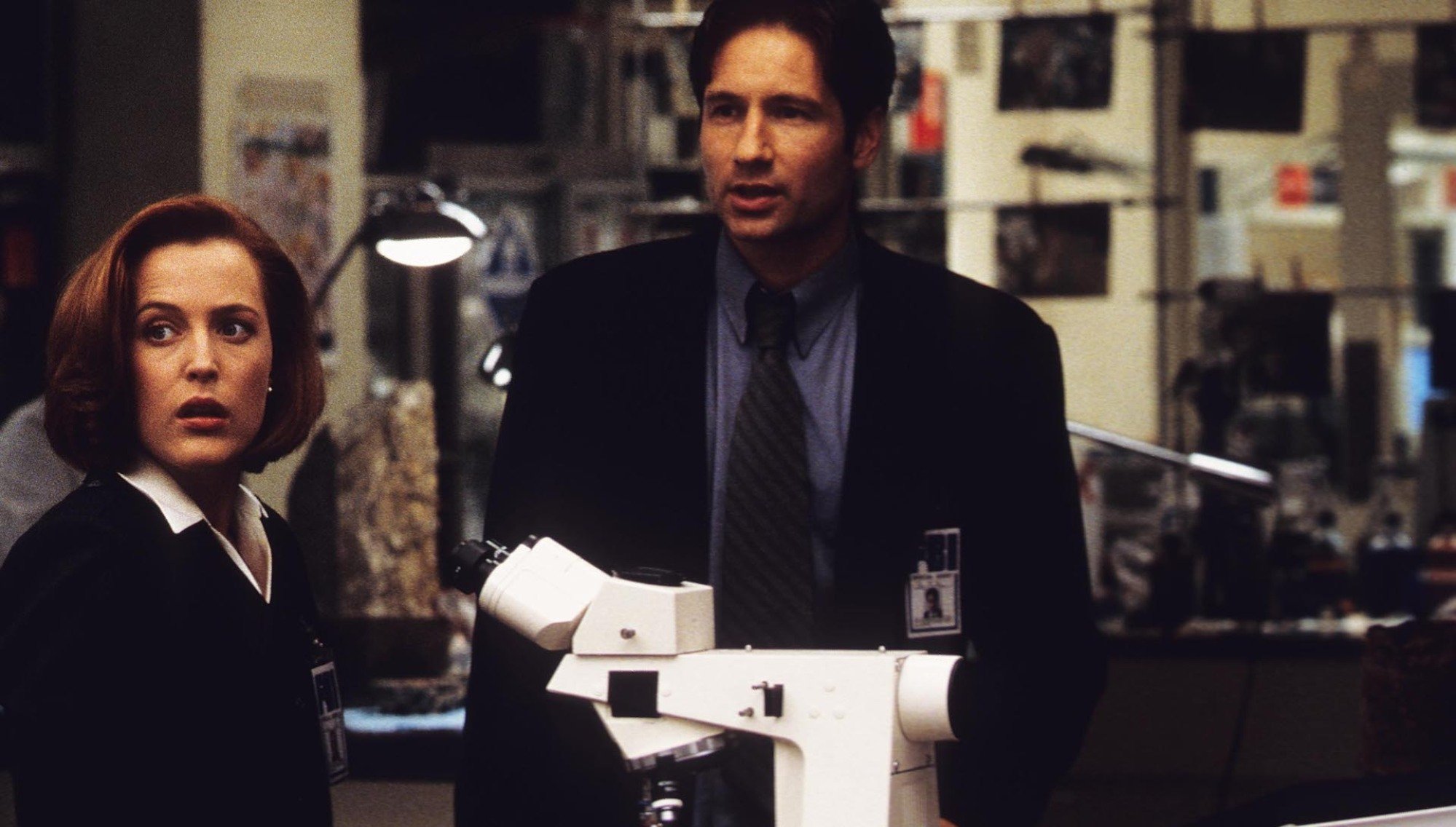 Agent Dana Scully (Gillian Anderson) and Agent Fox Mulder (David Duchovny) stand in a lab in "The X-Files."