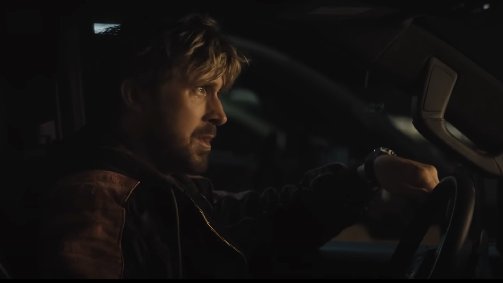 Ryan Gosling sits in his car crying.