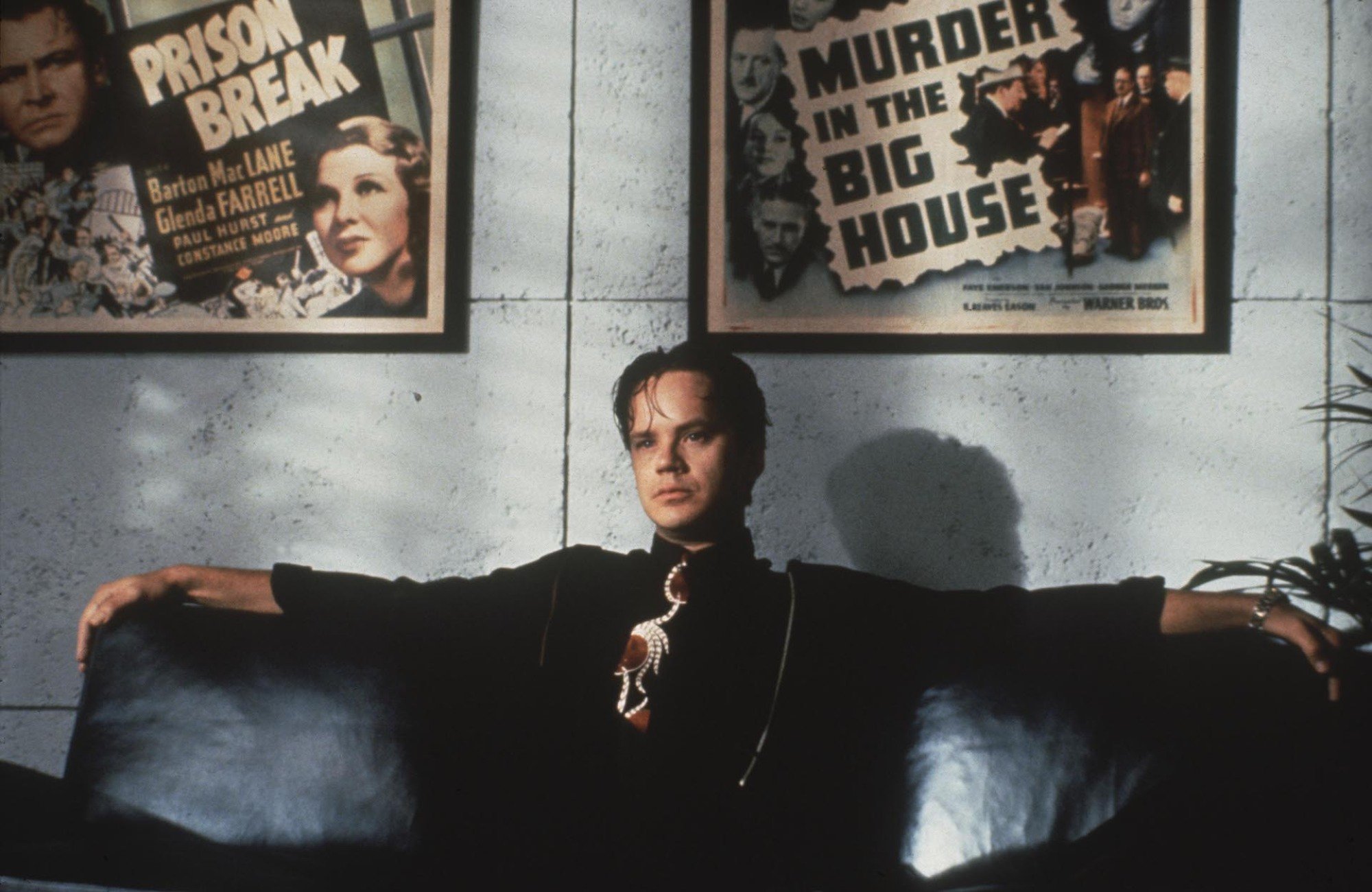 Tim Robbins sits in a chair in an office in "The Player."