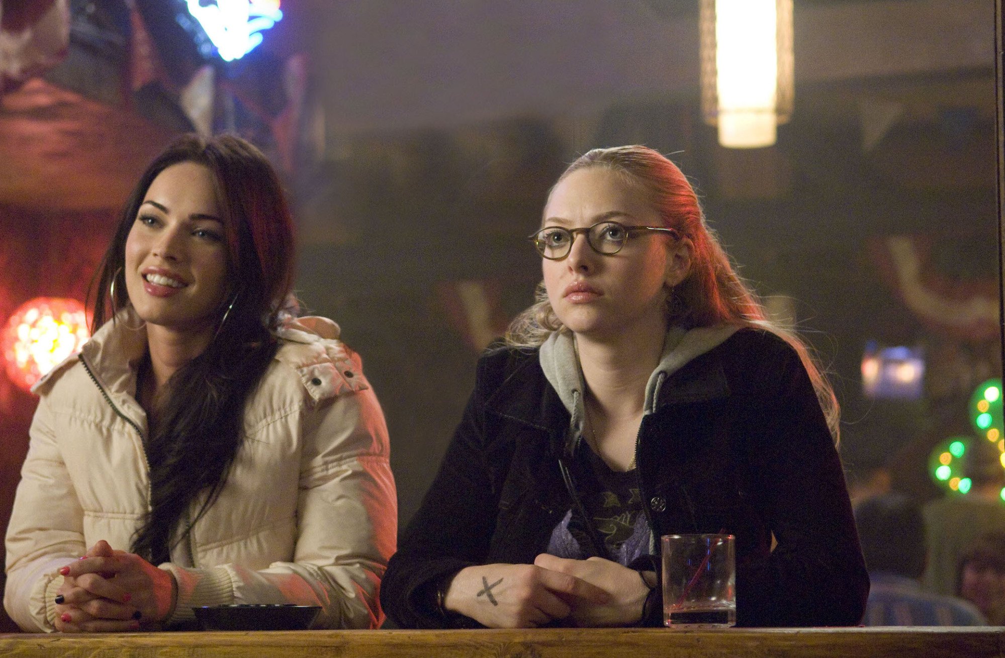 Megan Fox and Amanda Seyfried sit at a bar in "Jennifer's Body."