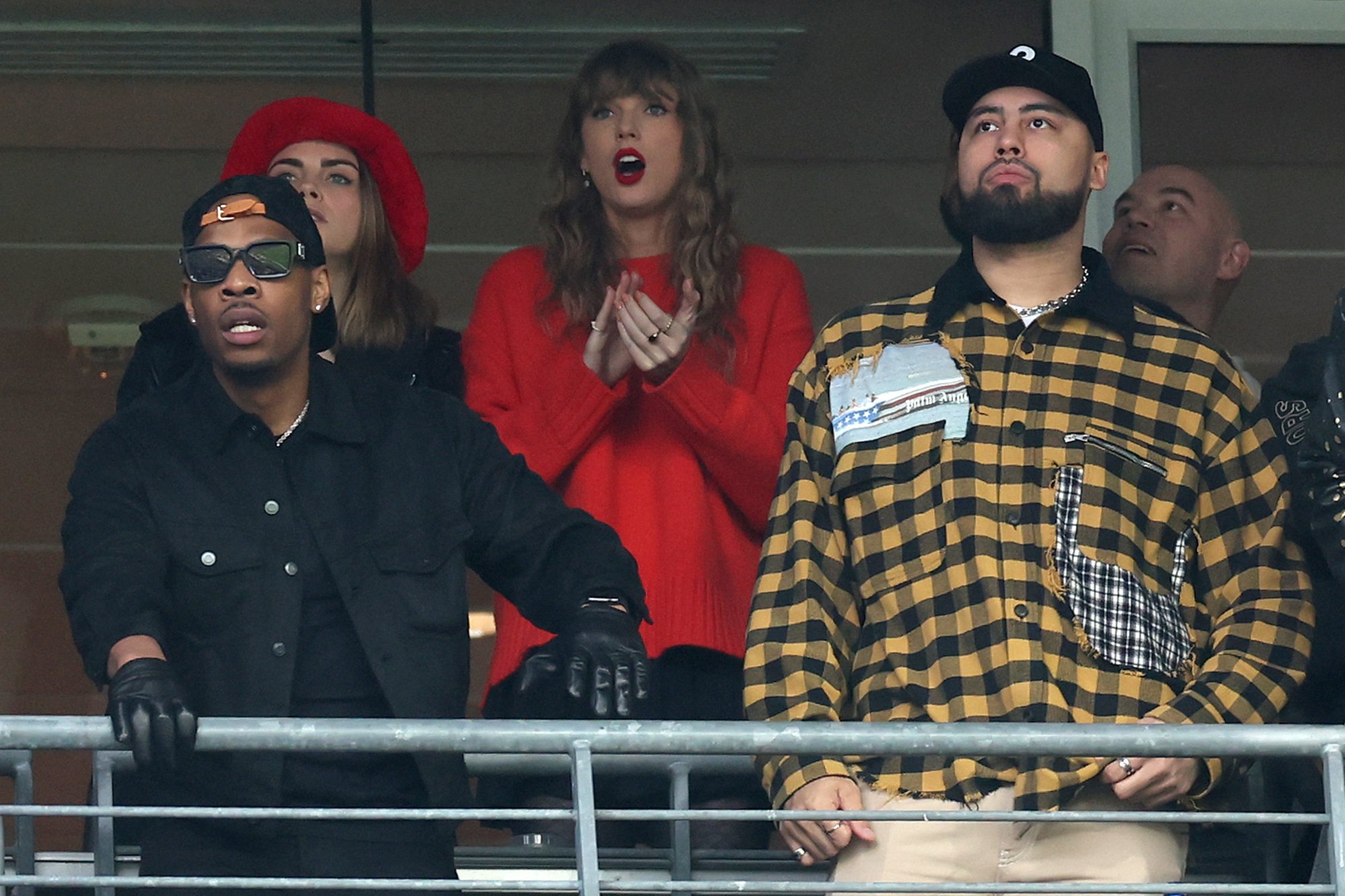 Swift and Delevigne in red at the AFC Championship game. 