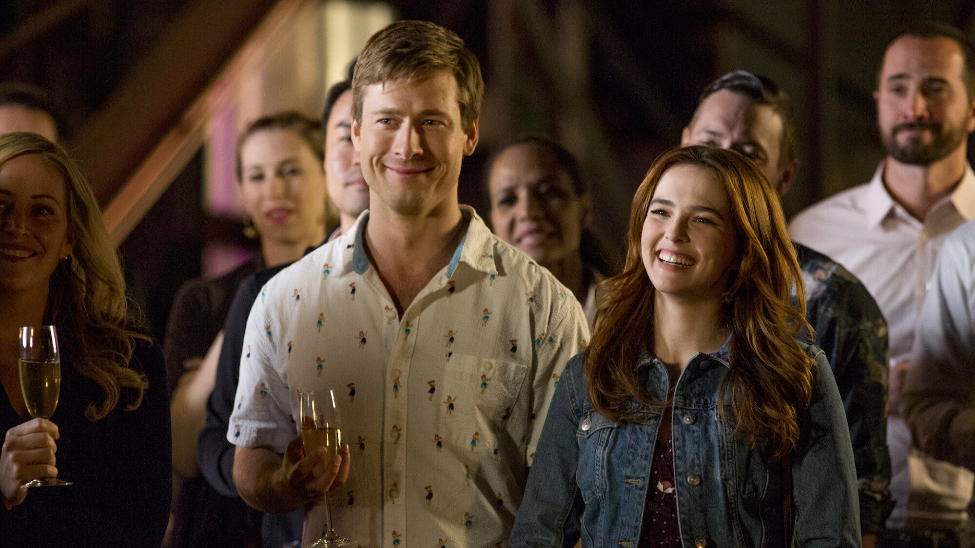 A man and a woman smile in a party.
