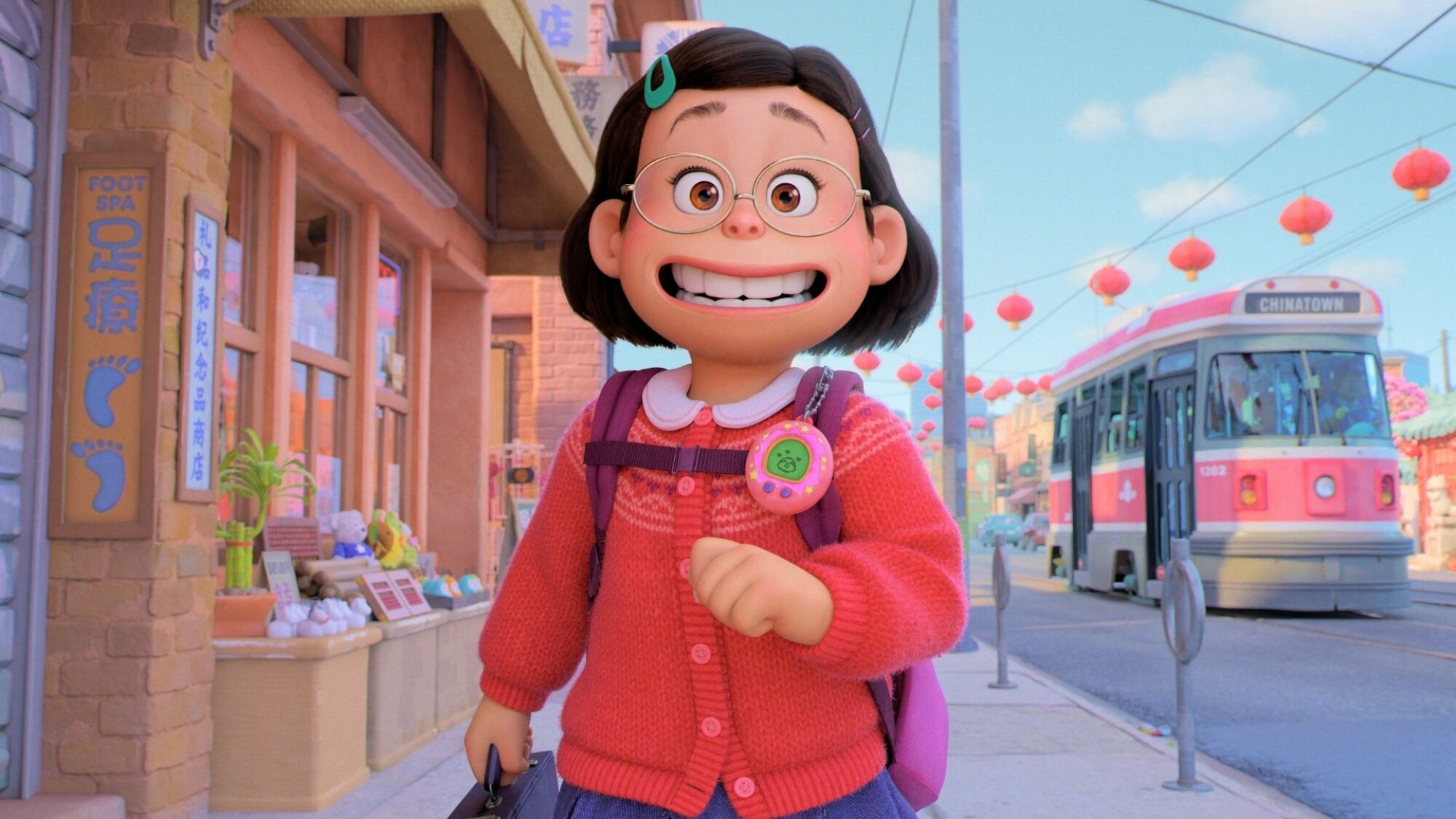 A little bespectacled girl walks down a Toronto street. 