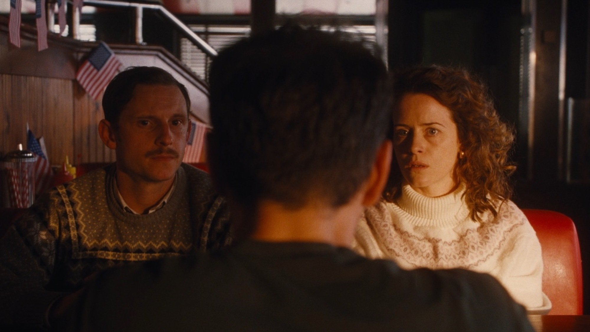 Jamie Bell, Andrew Scott, and Claire Foy at a diner in "All of Us Strangers."