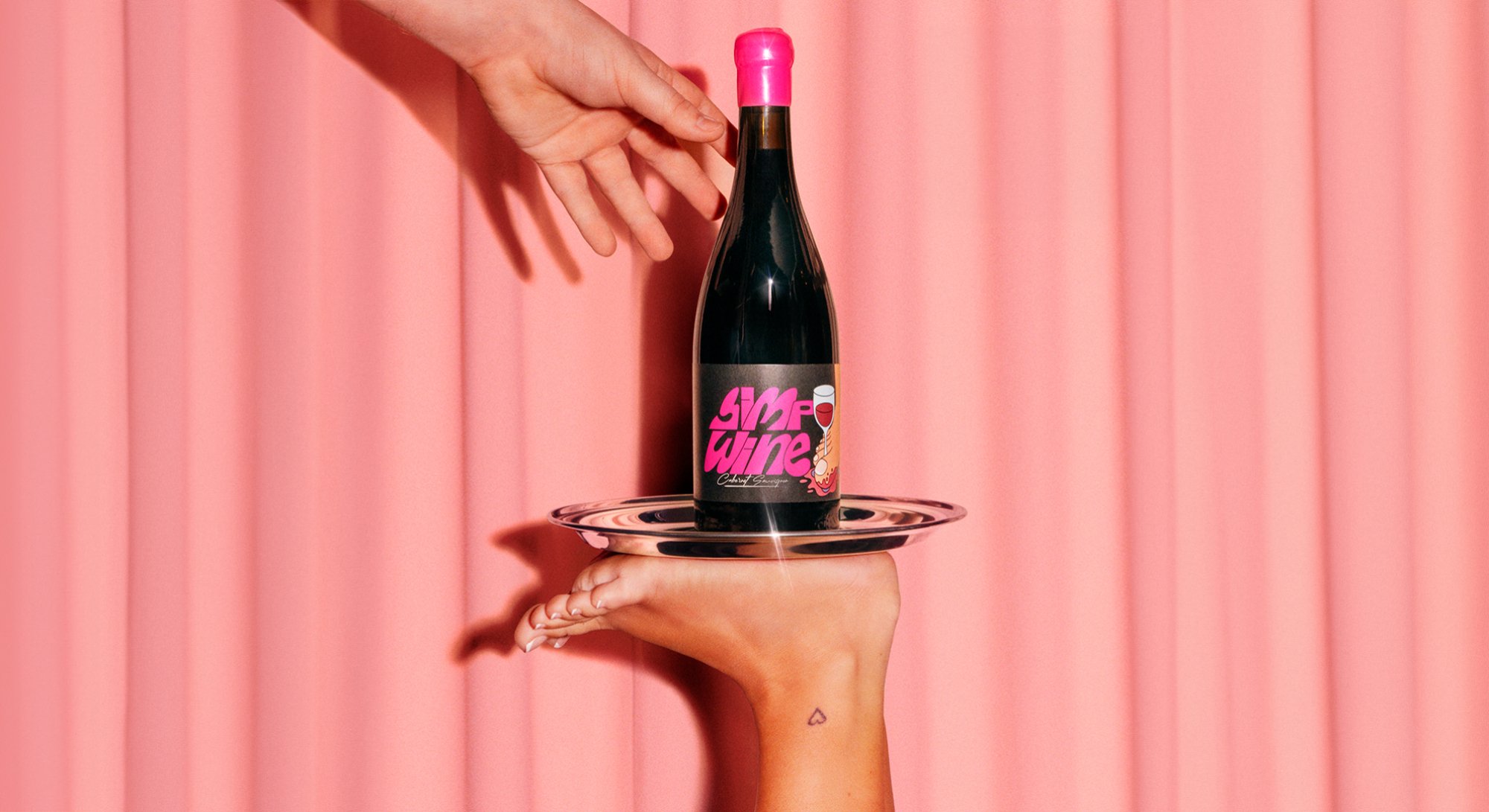 foot holding up tray of simp wine with hand reaching for it