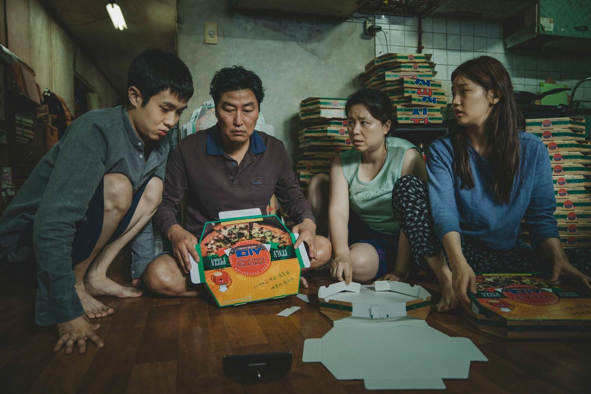 Kang-ho Song as Kim Ki-taek, Choi Woo-shik as Kim Ki-woo, Hye-jin Jang as Kim Chung-sook, and Park So-dam as Kim Ki-jung in "Parasite."