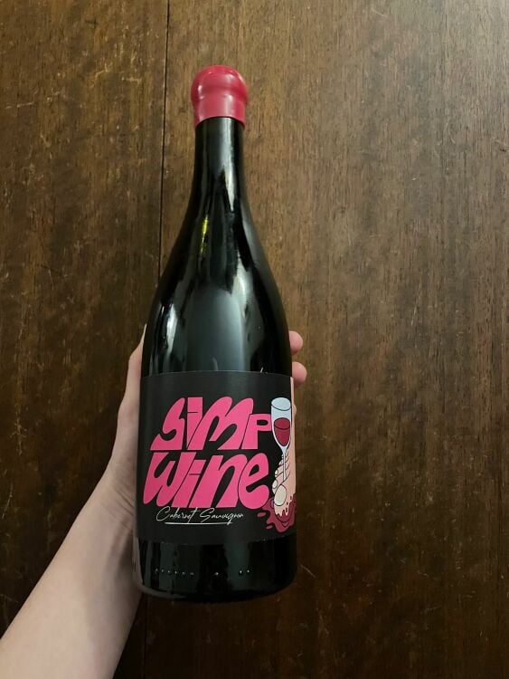 hand holding bottle of simp wine