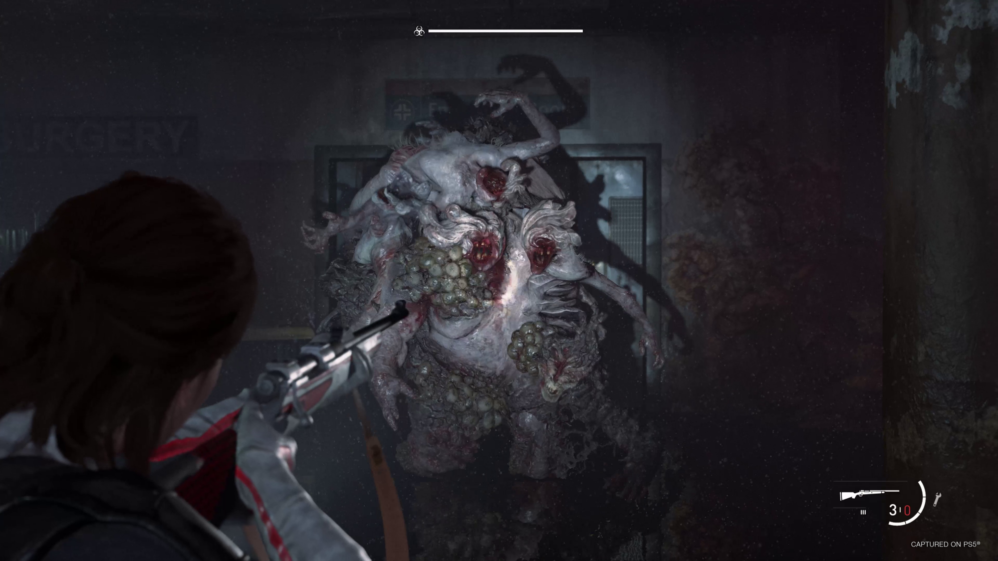 A brown hair girl aims a rifle at a grotesque rat king creature