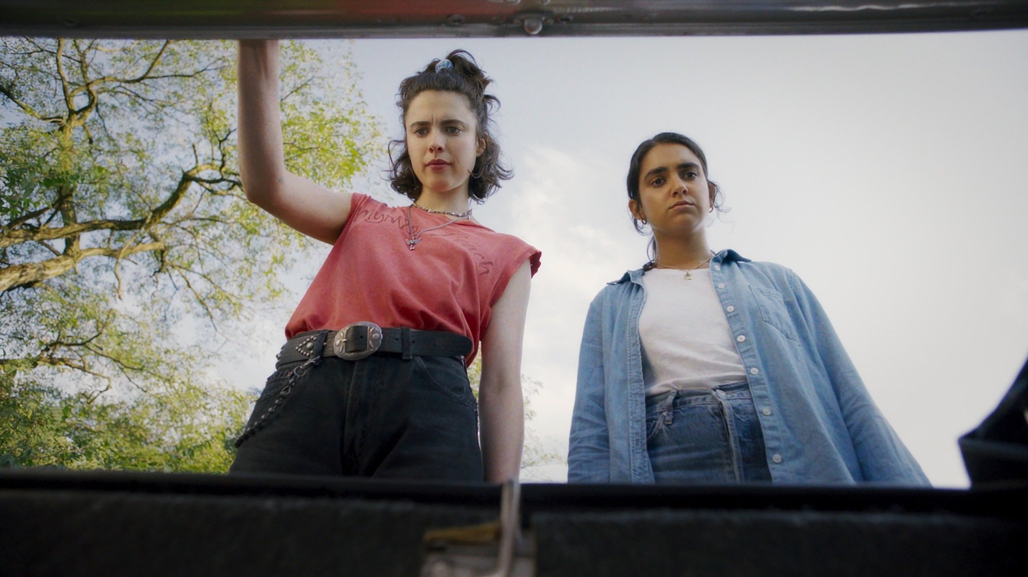 Geraldine Viswanathan and Margaret Qualley find a suitcase full of goodies in "Drive-Away Dolls."