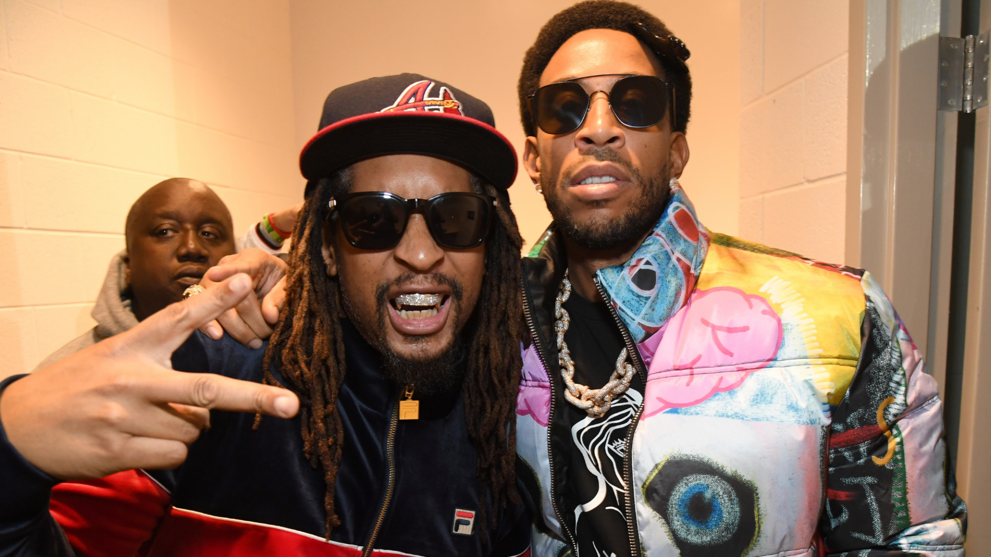 Lil Jon, making a peace sign, and Ludacris