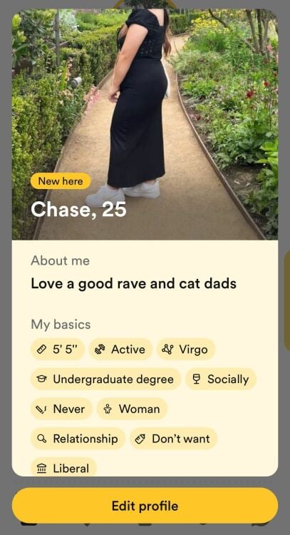 This image shows a screenshot of a dating profile for a person named Chase, who is 25 years old. The profile includes a photo of Chase from behind, wearing a black dress and white shoes, standing on a garden path surrounded by greenery and flowers. The profile text indicates a love for raves and cat dads, lists personal details such as being 5'5" tall, active, a Virgo, holding an undergraduate degree, and being a social drinker. Chase identifies as a woman, is interested in a relationship, does not want children, and identifies as liberal. There is a button at the bottom to edit the profile.