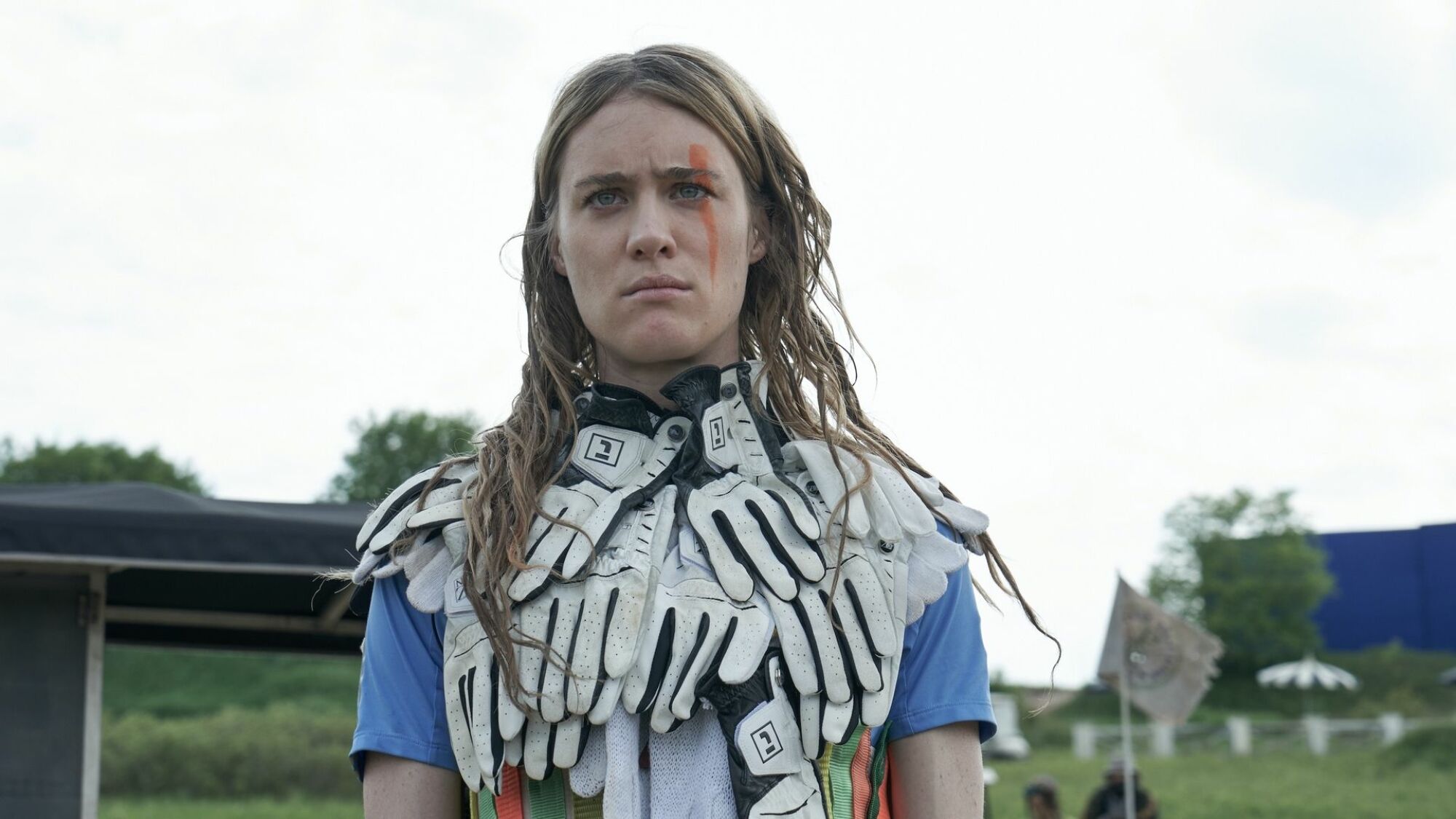 A young woman in odd clothing looks concerned.