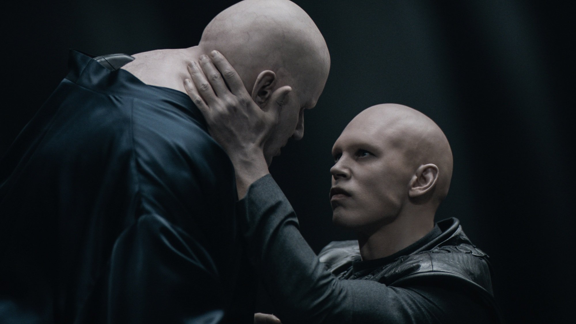 Feyd-Rautha Harkonnen holds Baron Harkonnen's face as he floats above him.
