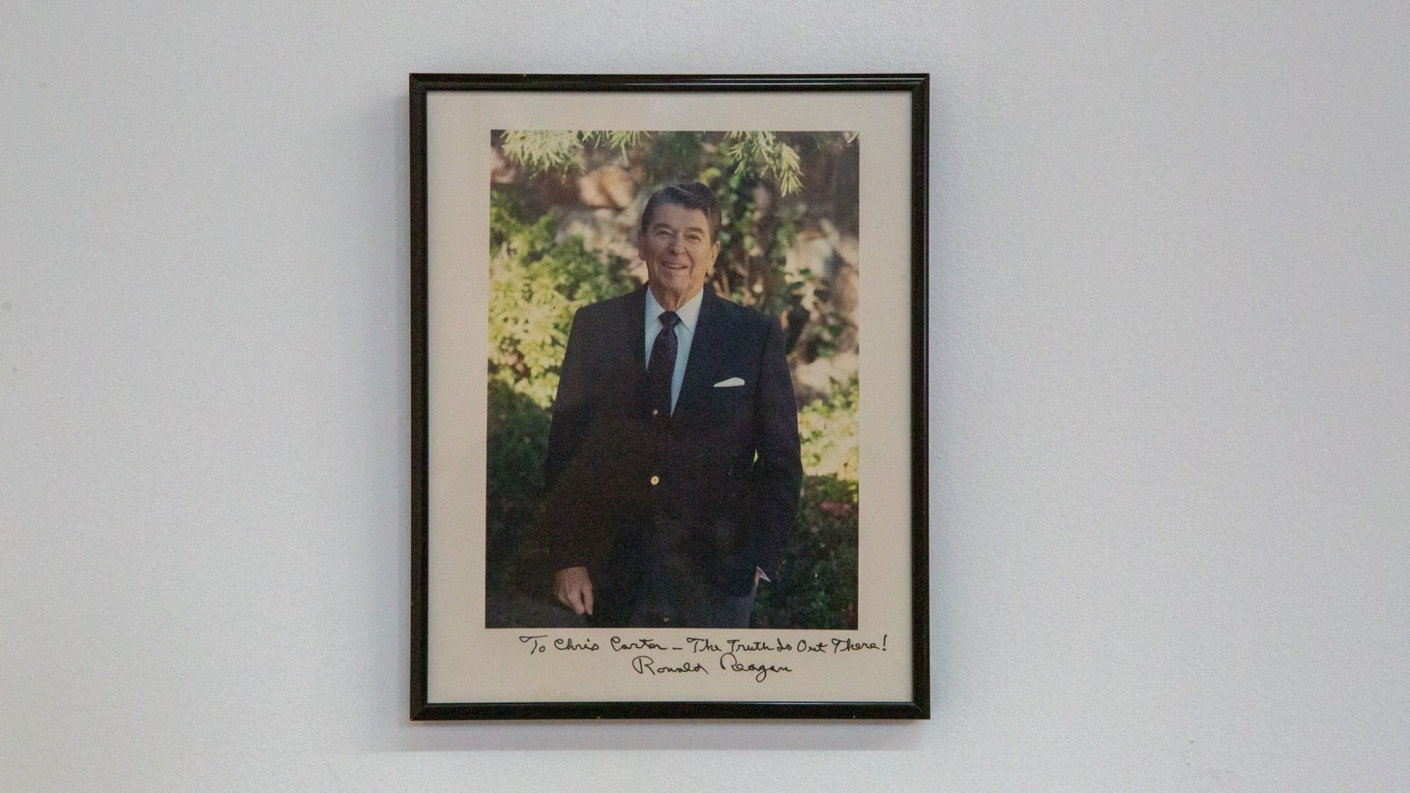 A framed photo of President Ronald Reagan.