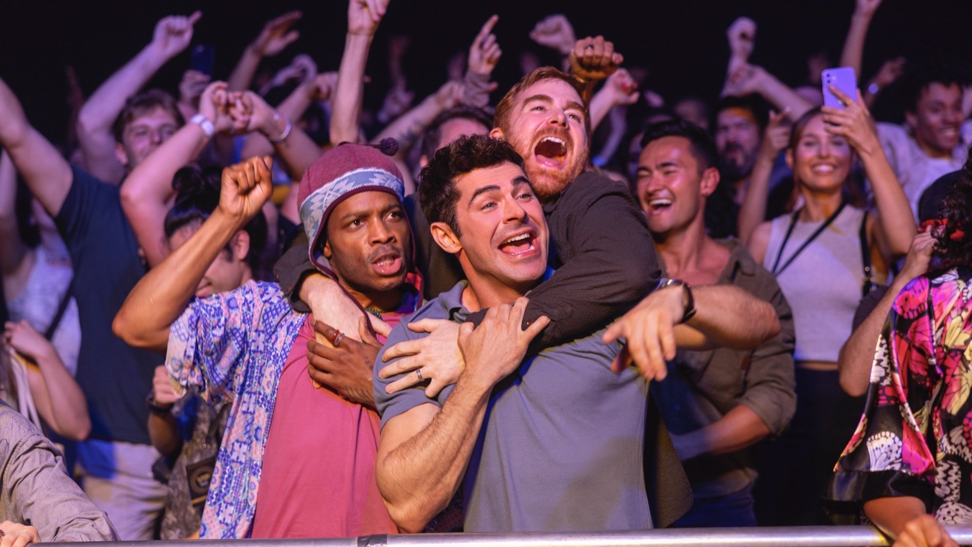 Three men party at a DJ set.