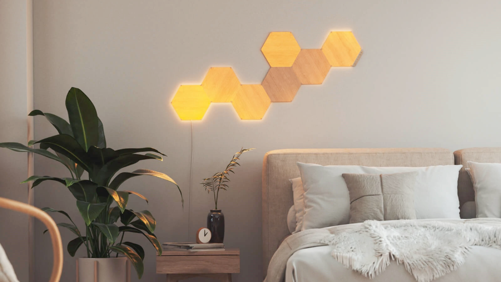 Nanoleaf's Elements Hexagons Smarter Kit above a bed.
