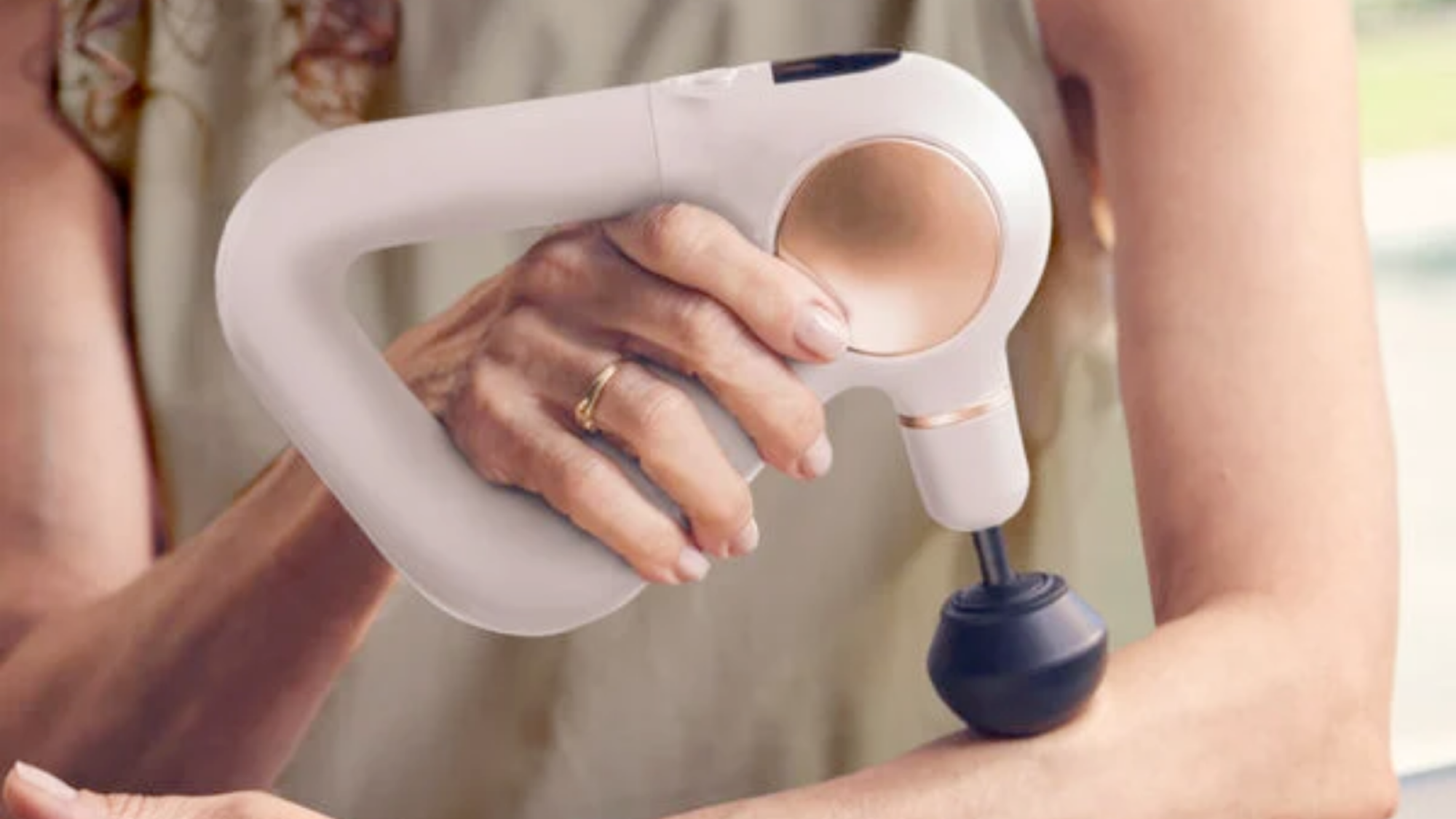 The Theragun Sense massage gun.