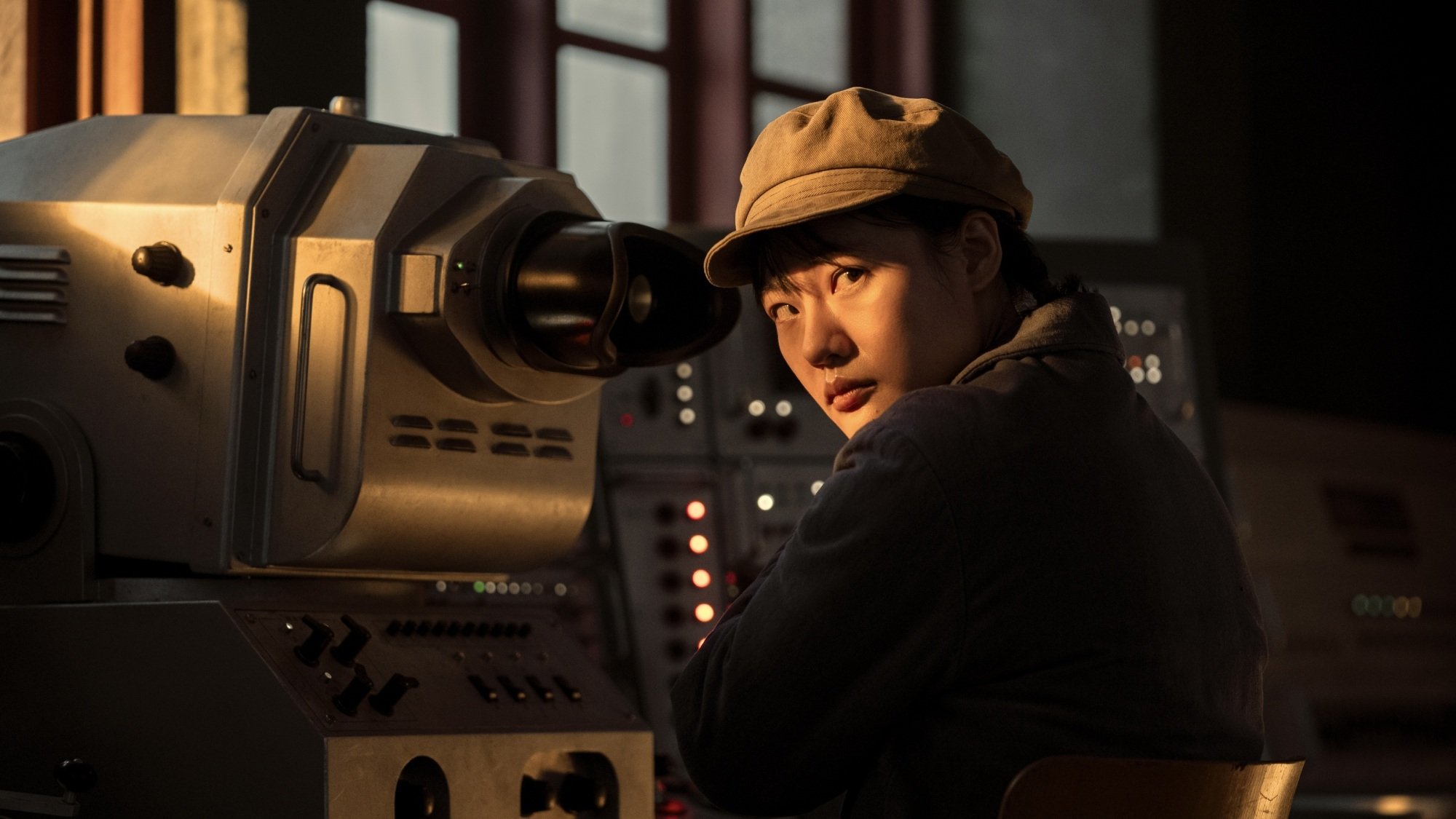 A young woman next to a viewfinder in a military base.