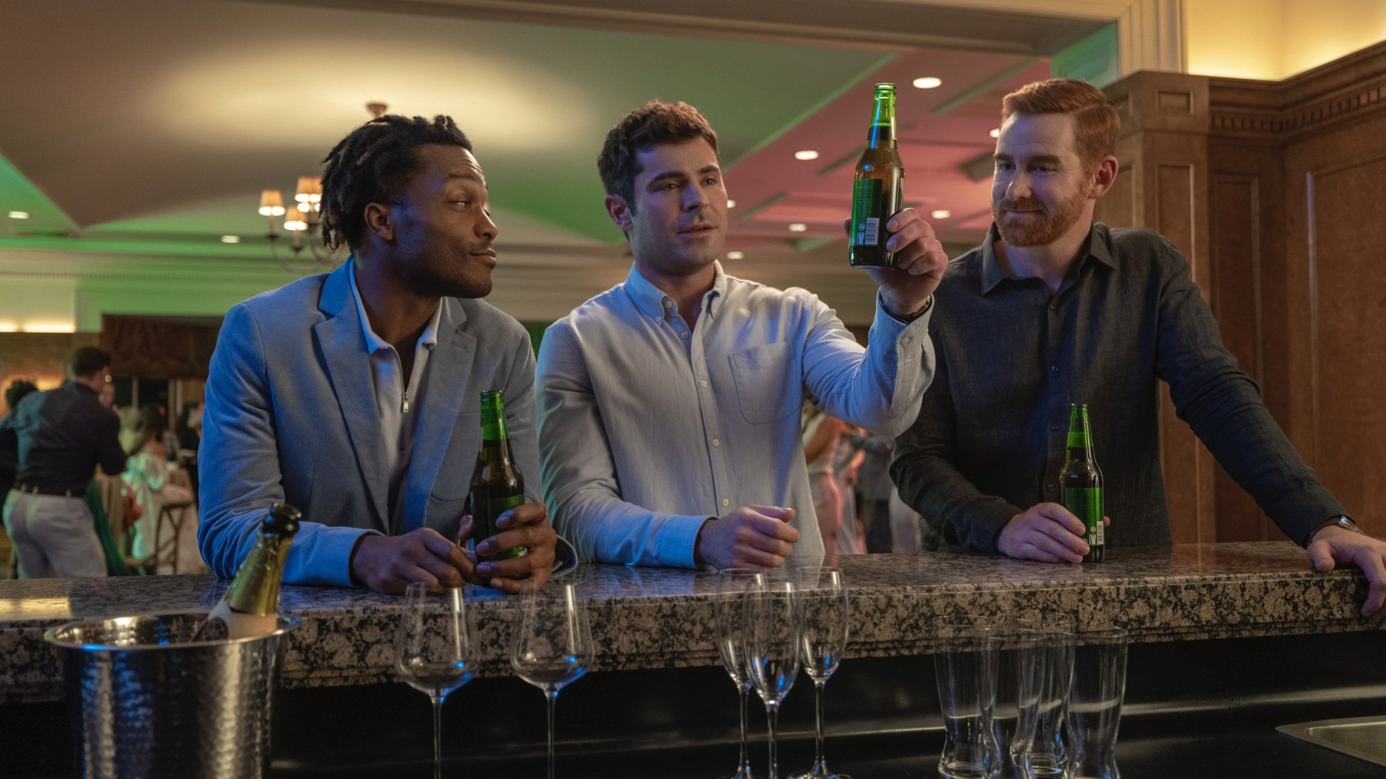 Three men raise a toast at a bar.