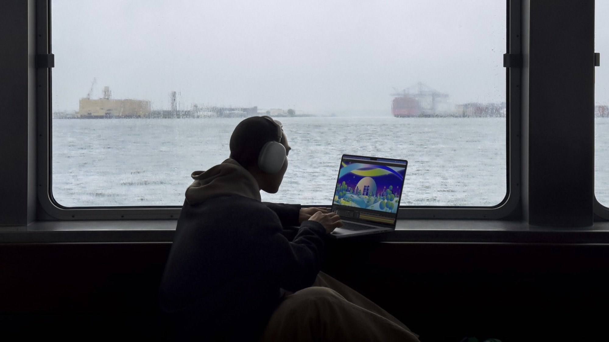 person on ferry working on M3 macbook pro