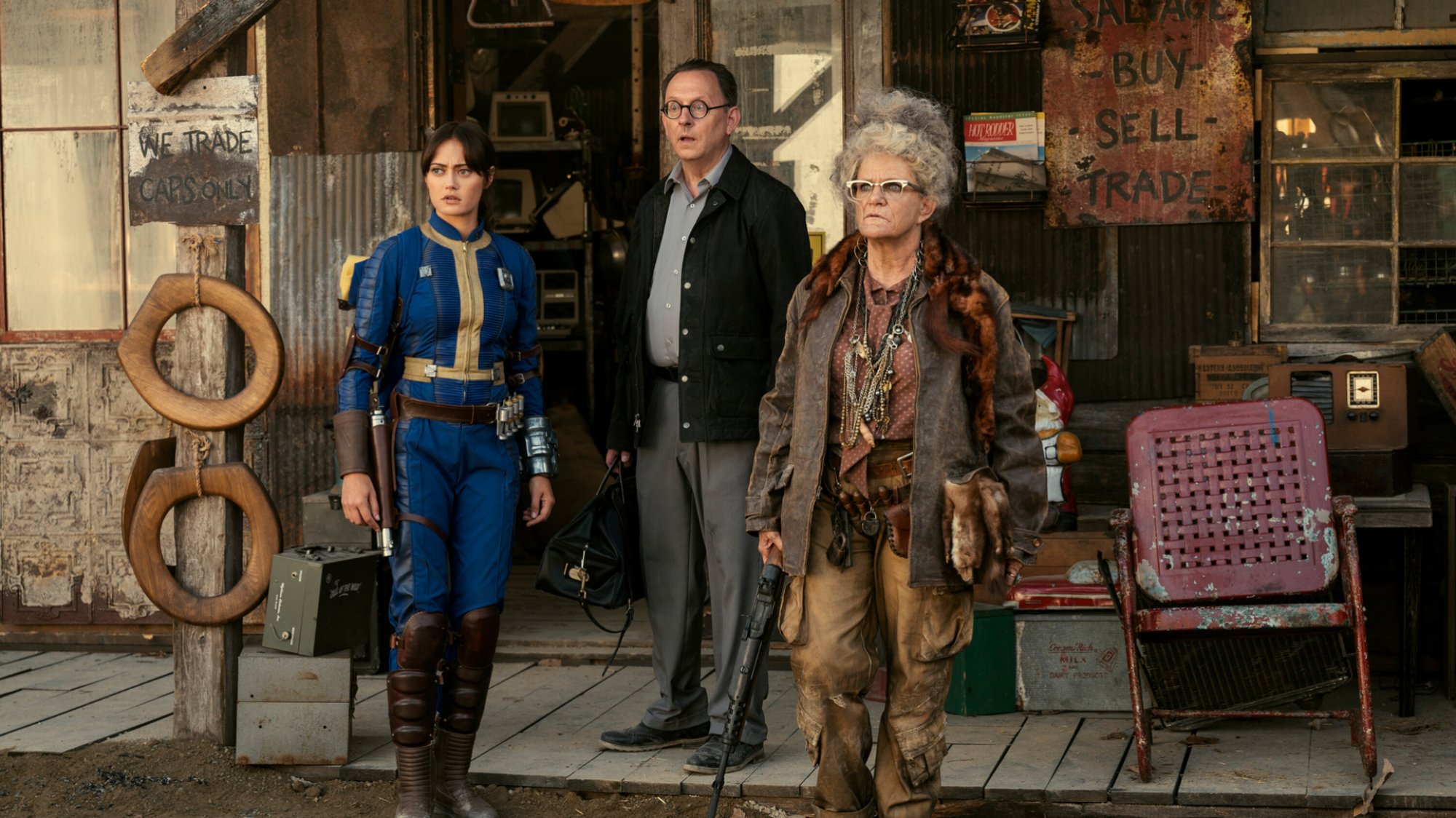 Ella Purnell, Michael Emerson, and Dale Dickey stand outside a shop in "Fallout."