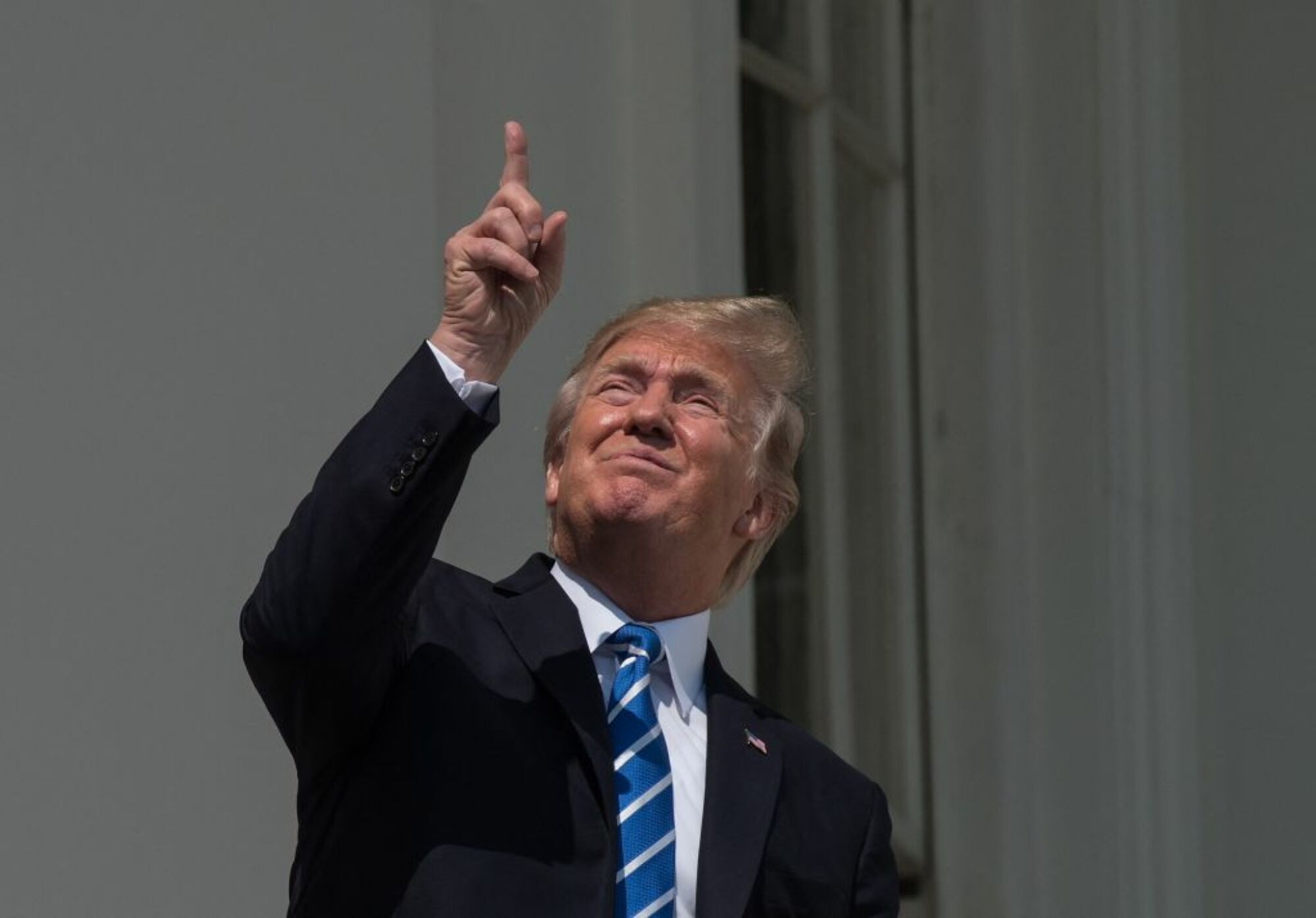 Former President Donald Trump looking at the sun with the naked eye