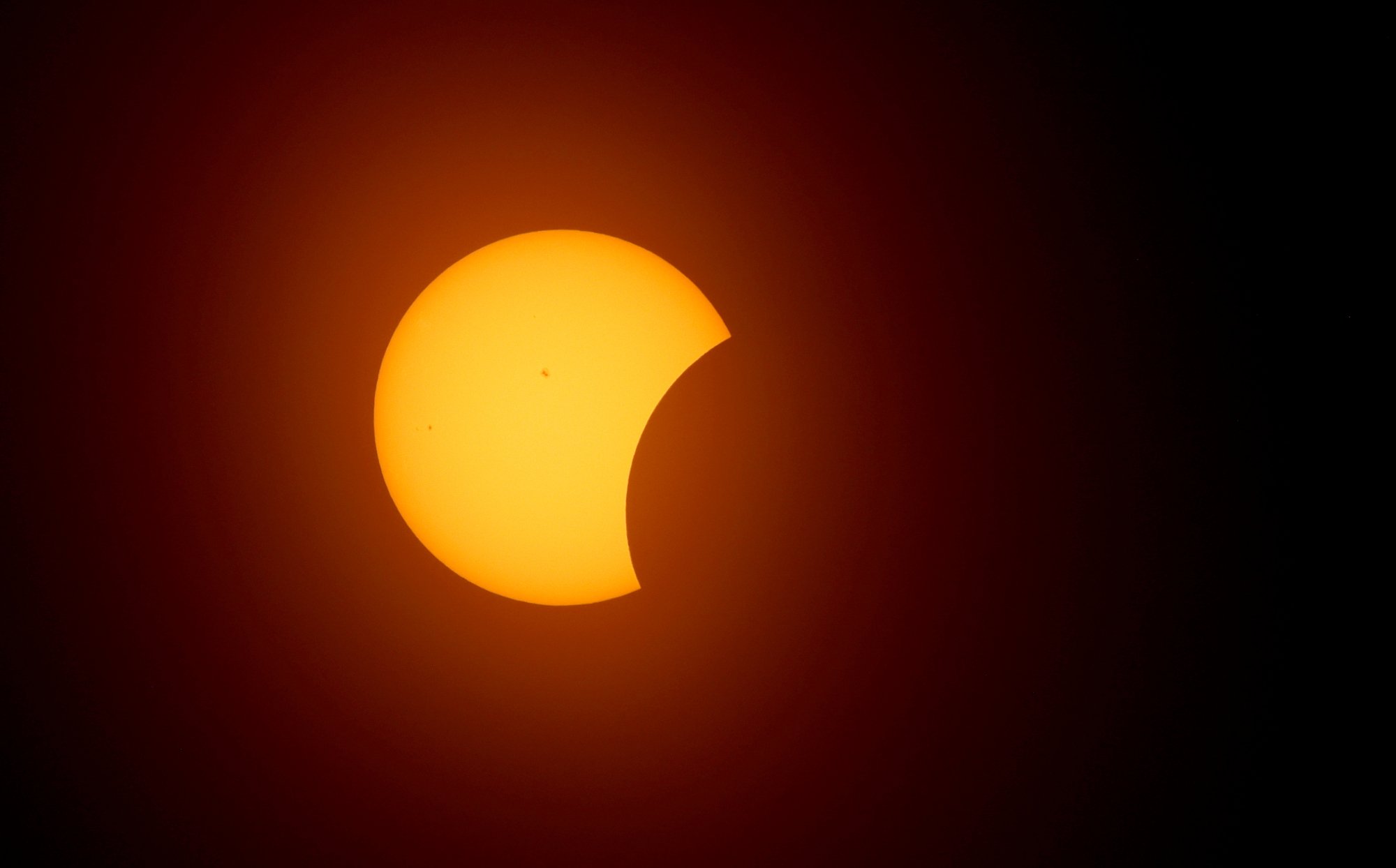 sun beginning to be covered by moon