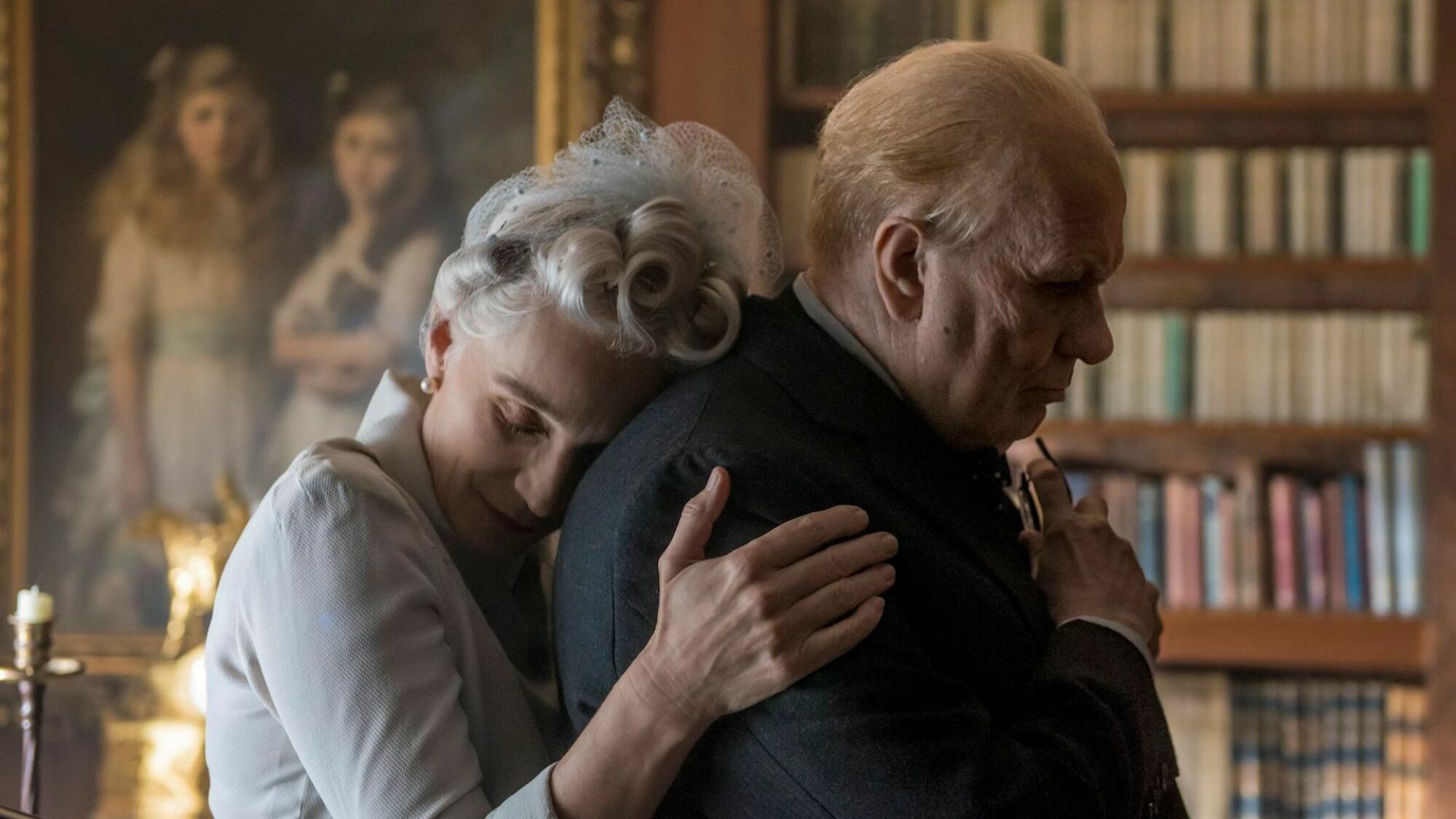 An old woman hugs her husband.