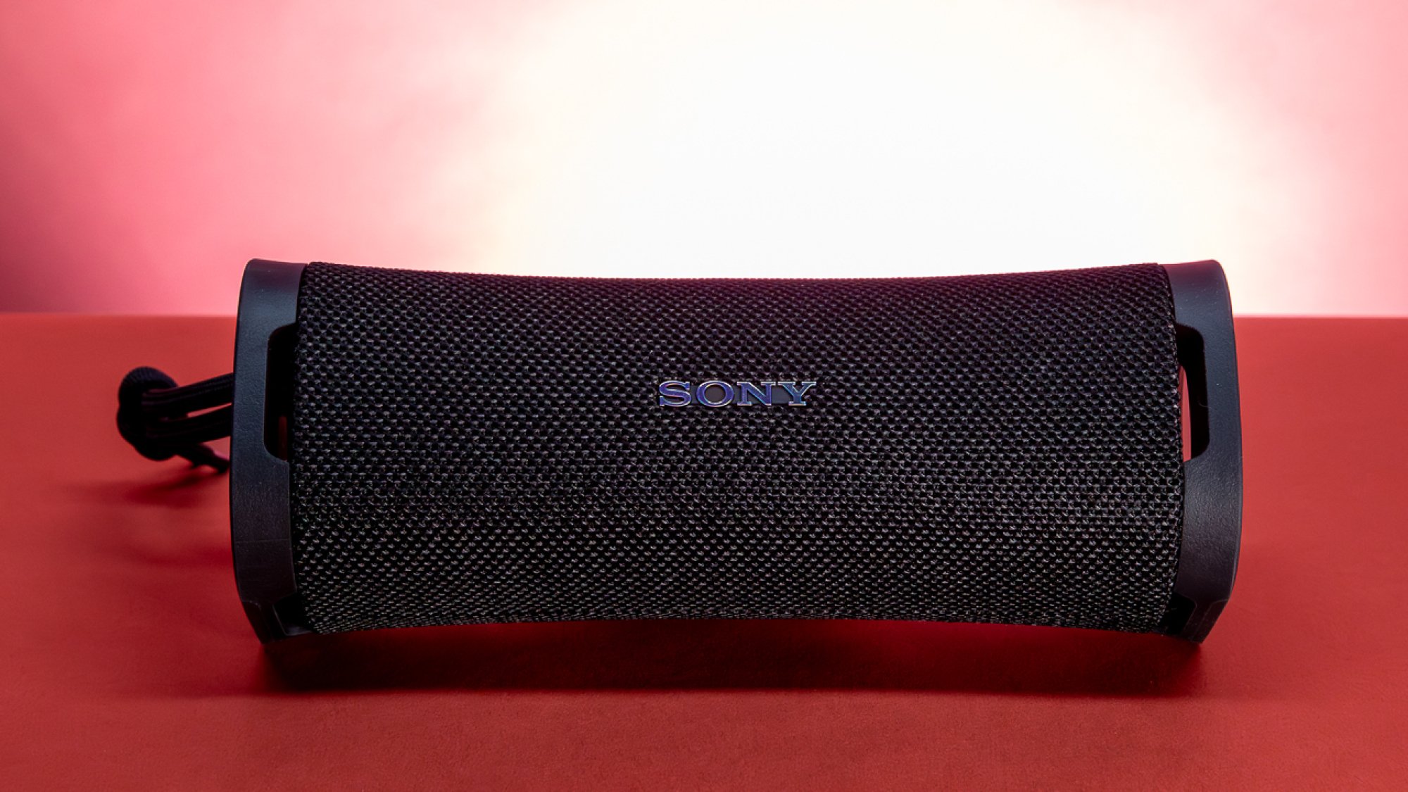 black rectangular sony speaker against red background