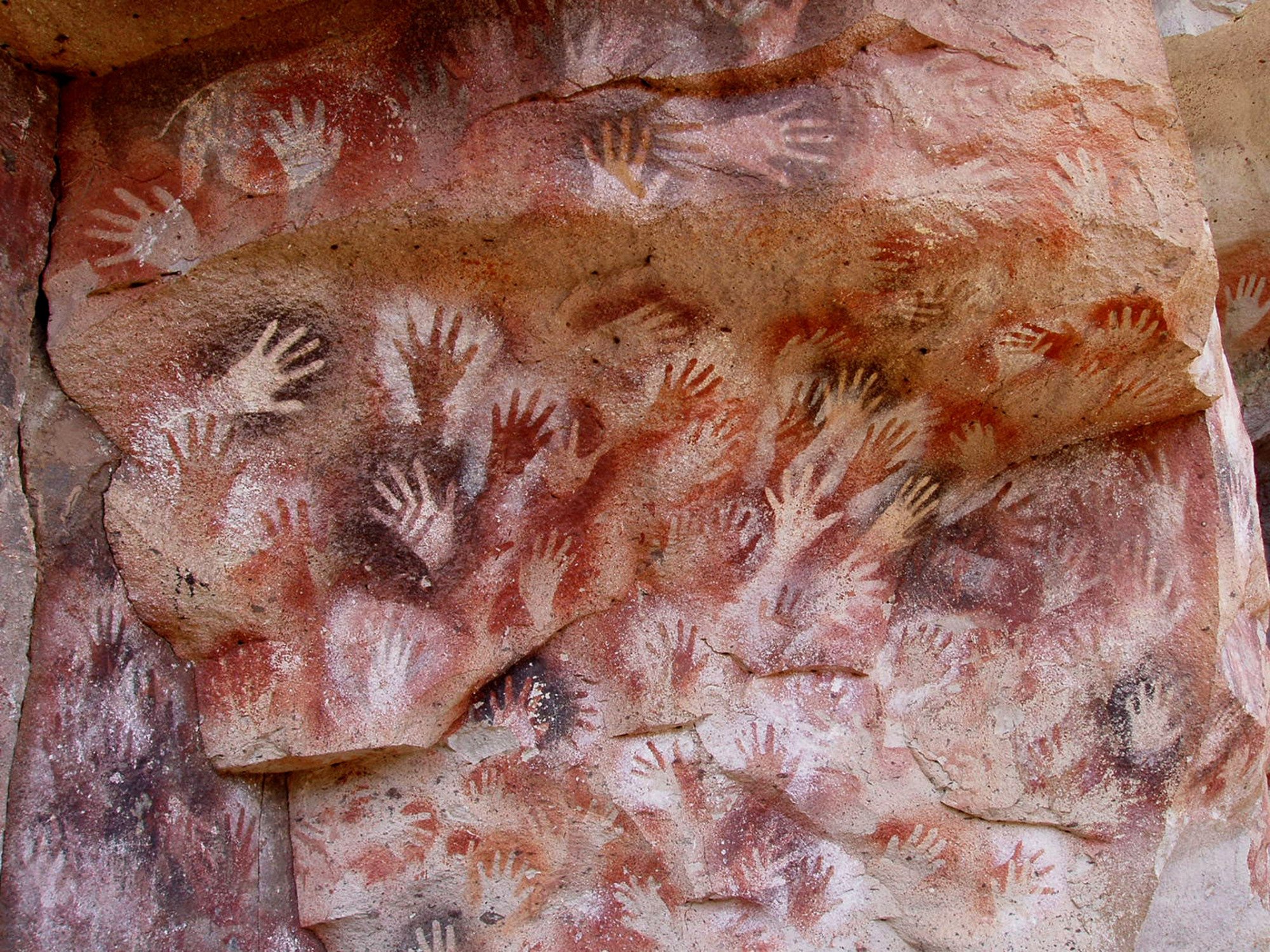 A cave painting with images of hands